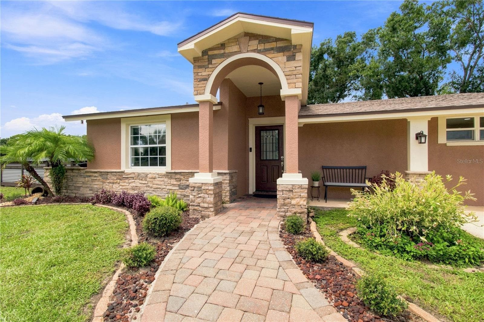 Front View warm color stone decor blends for a cohesive upgrade look, with Portico and Porch, paved walkway to complete the beautiful curb appeal. - 9020 AUBURN WAY, TAMPA