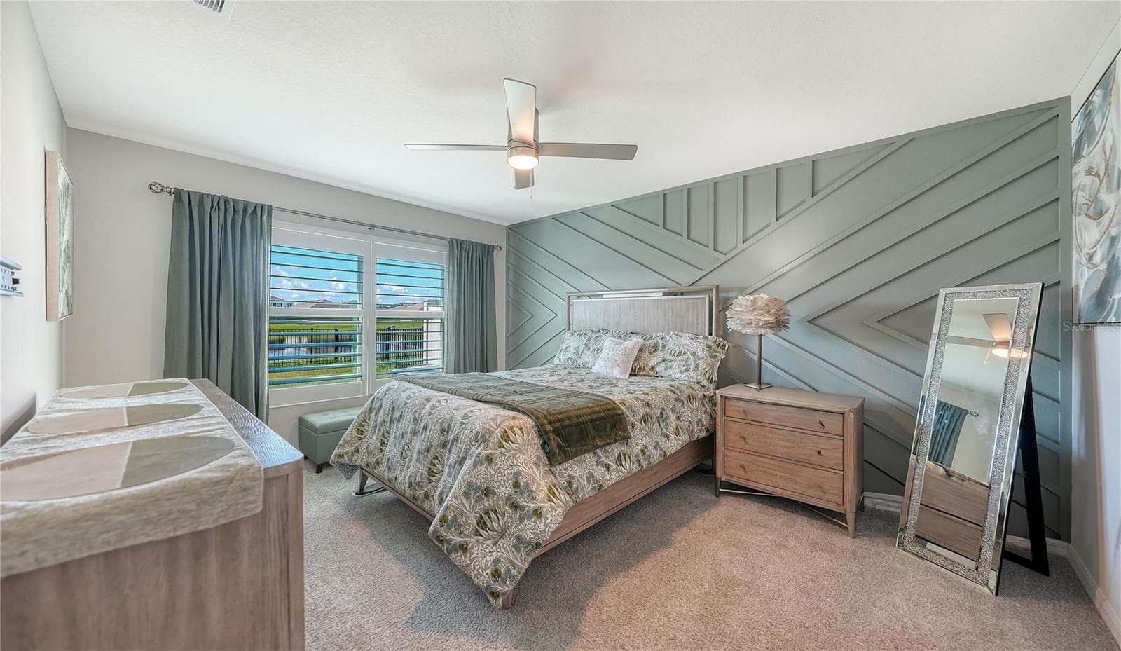 Primary bedroom overlooking the pretty pond and the water fountain at the back of the home. - 10402 CHARLOTTE DR, PARRISH