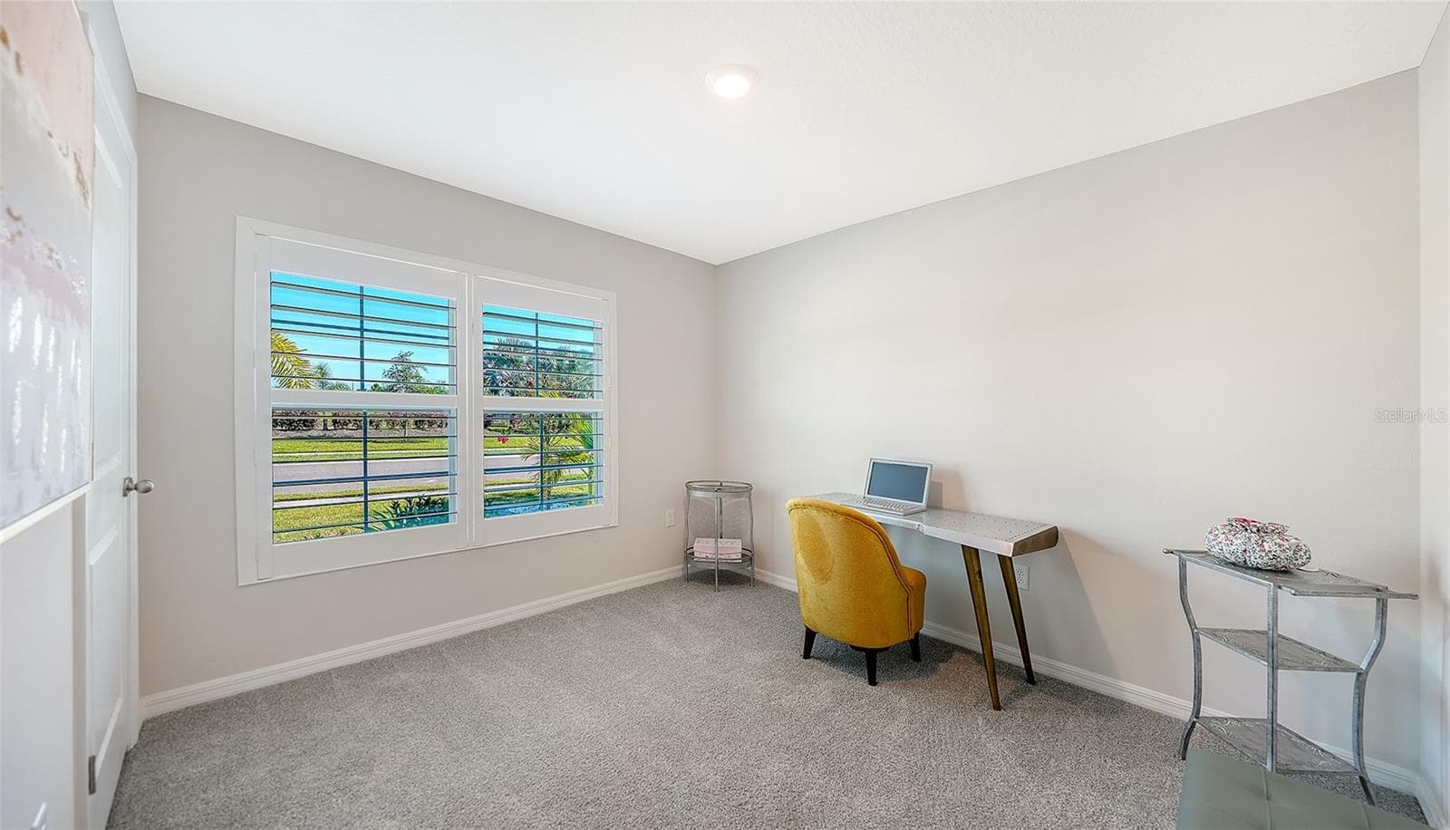 Guest bedroom in the front of the home overlooking the pond across the street. - 10402 CHARLOTTE DR, PARRISH