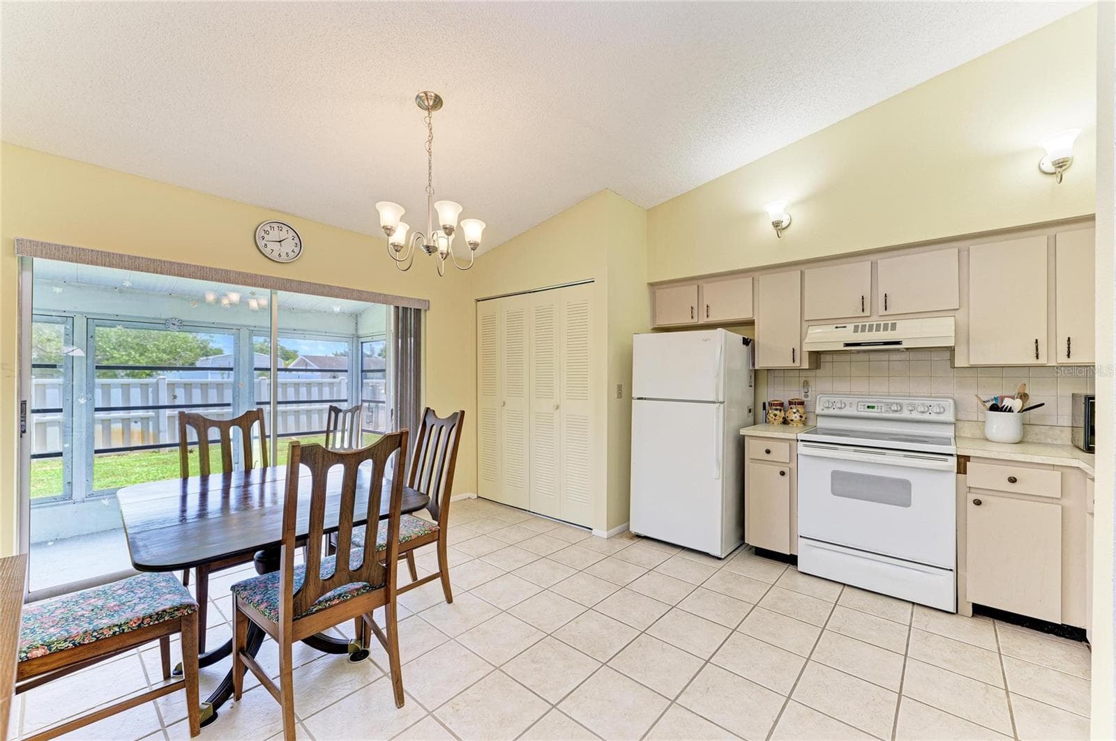 Kitchen with laundry closet and sliders to the Florida room. - 3403 36TH ST W #109, BRADENTON