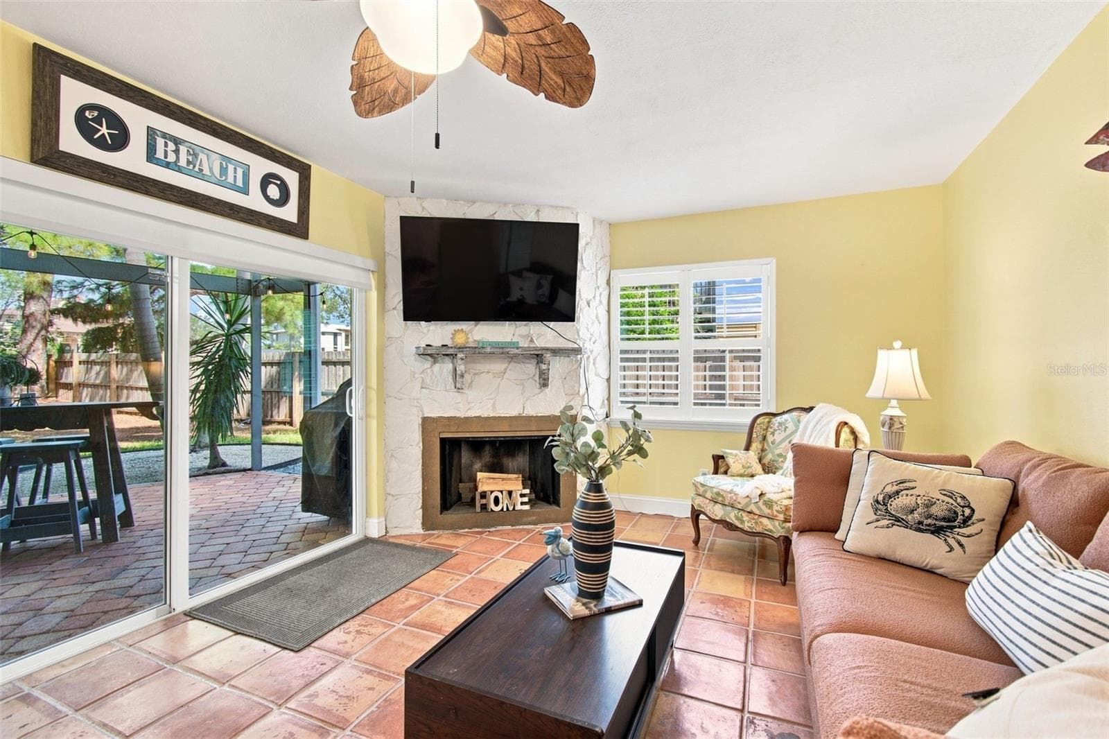 Downstairs living area with wood burning fireplace - 201 LAGOON DR, PALM HARBOR