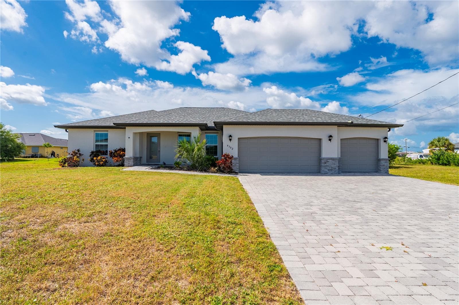 Outside View of Home with Pavered Driveway - 4302 NW 32ND ST, CAPE CORAL