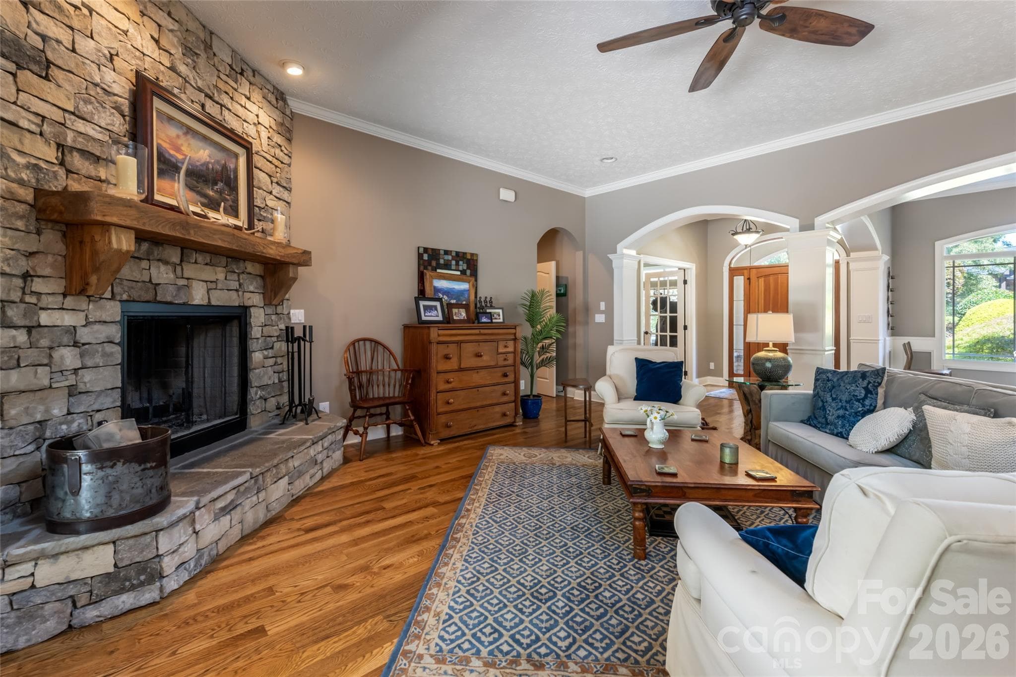 Living room with wood burning fireplace looking towards front door - 170 Cape Martin Circle, Hendersonville