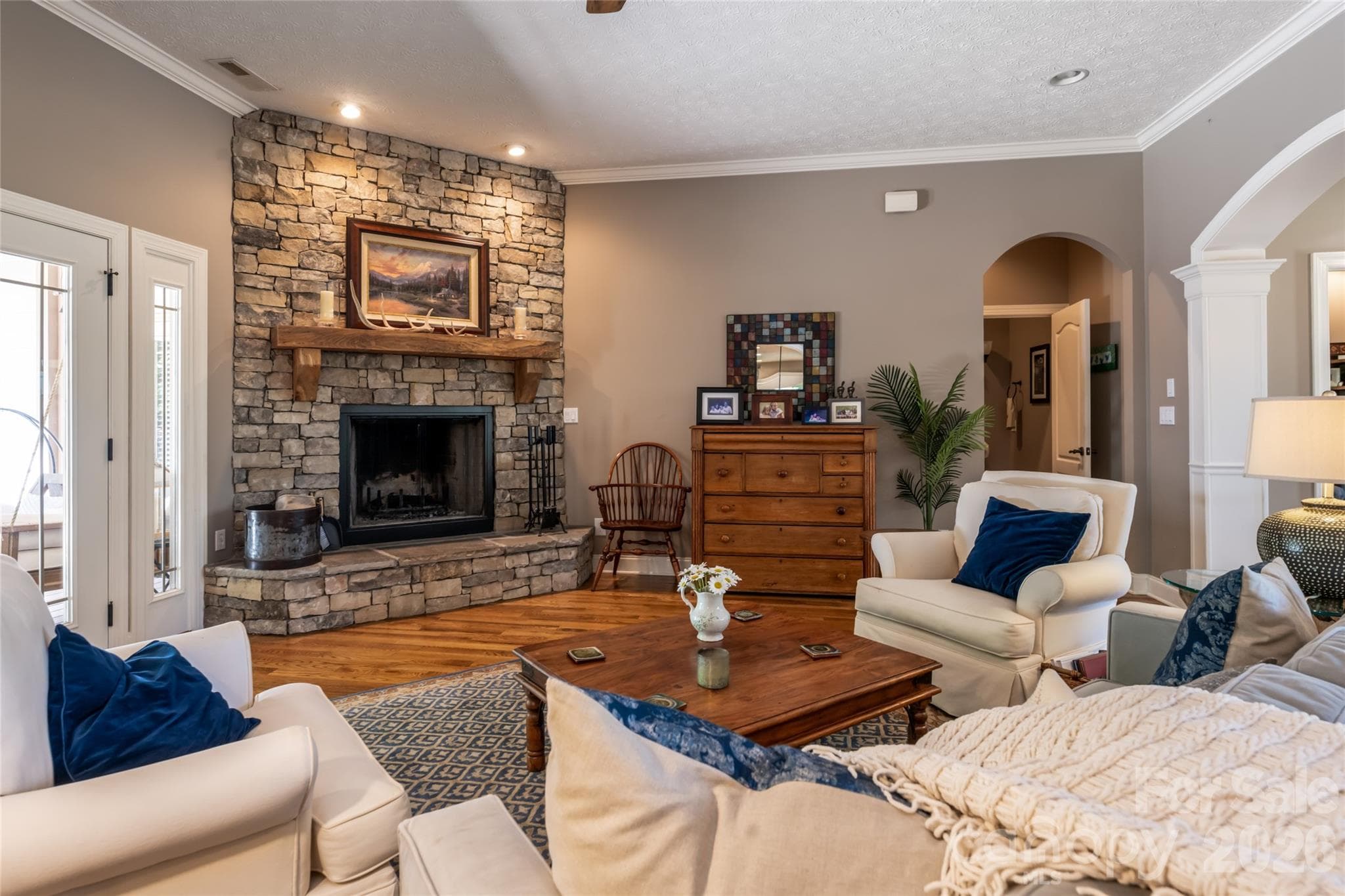 Living room with wood burning fireplace and access to upper deck through covered area - 170 Cape Martin Circle, Hendersonville