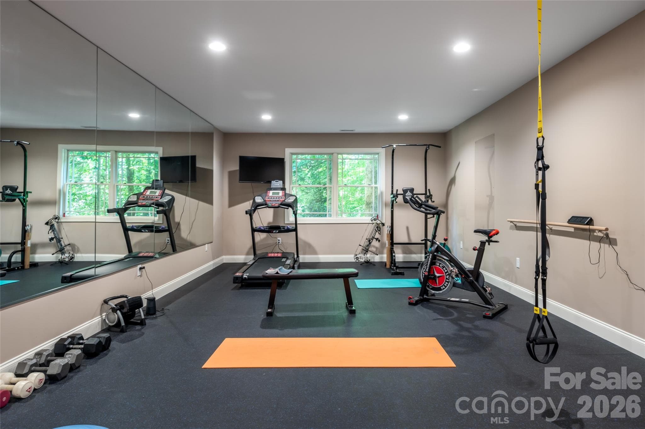 Doubled the size of the house by adding a downstairs that includes two large bedrooms, a full bath with a double sink, craft/video room, rec room, gym and storage - 170 Cape Martin Circle, Hendersonville