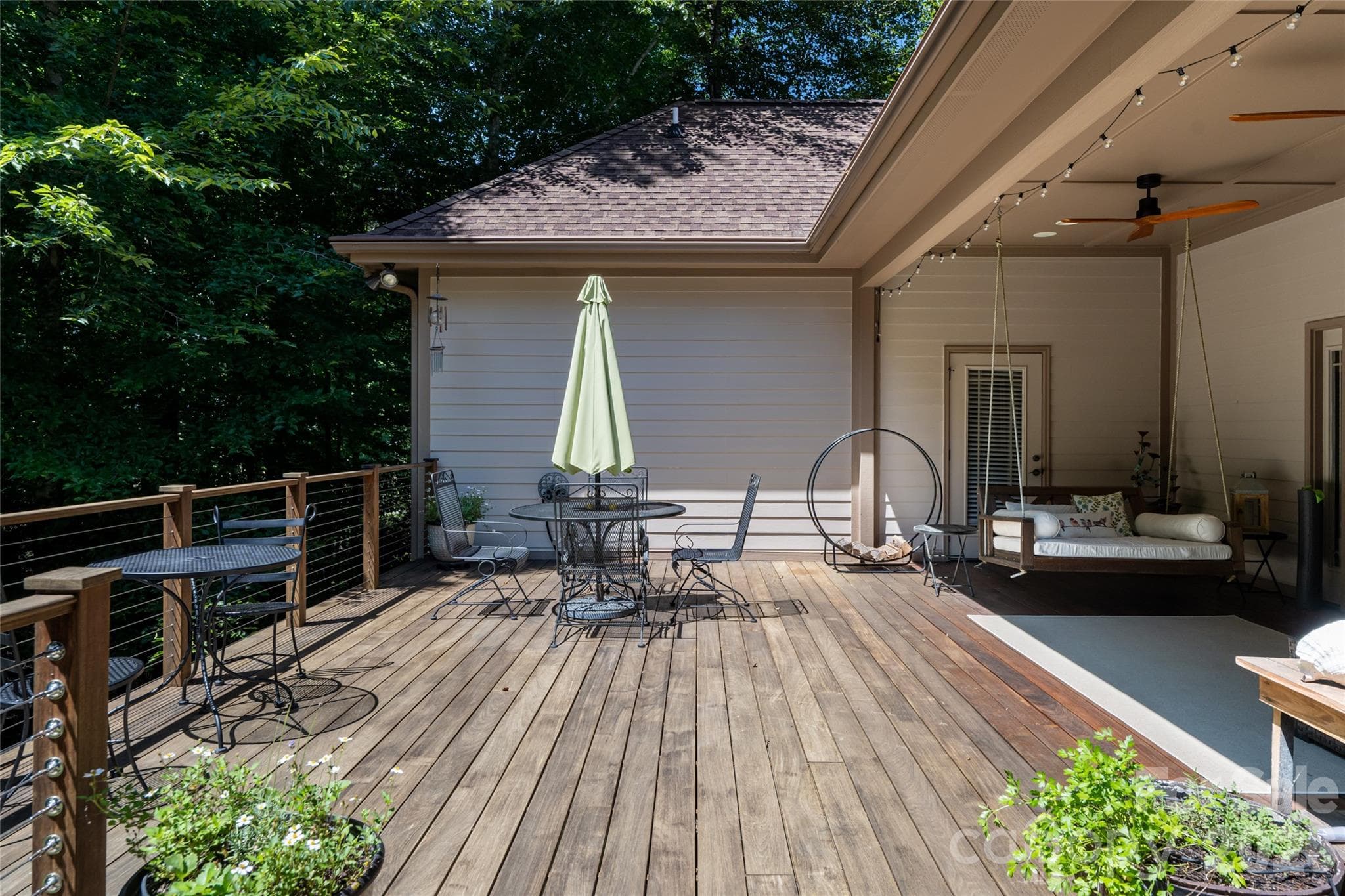 A large, private back porch with Ipe flooring and a hanging porch bed - 170 Cape Martin Circle, Hendersonville