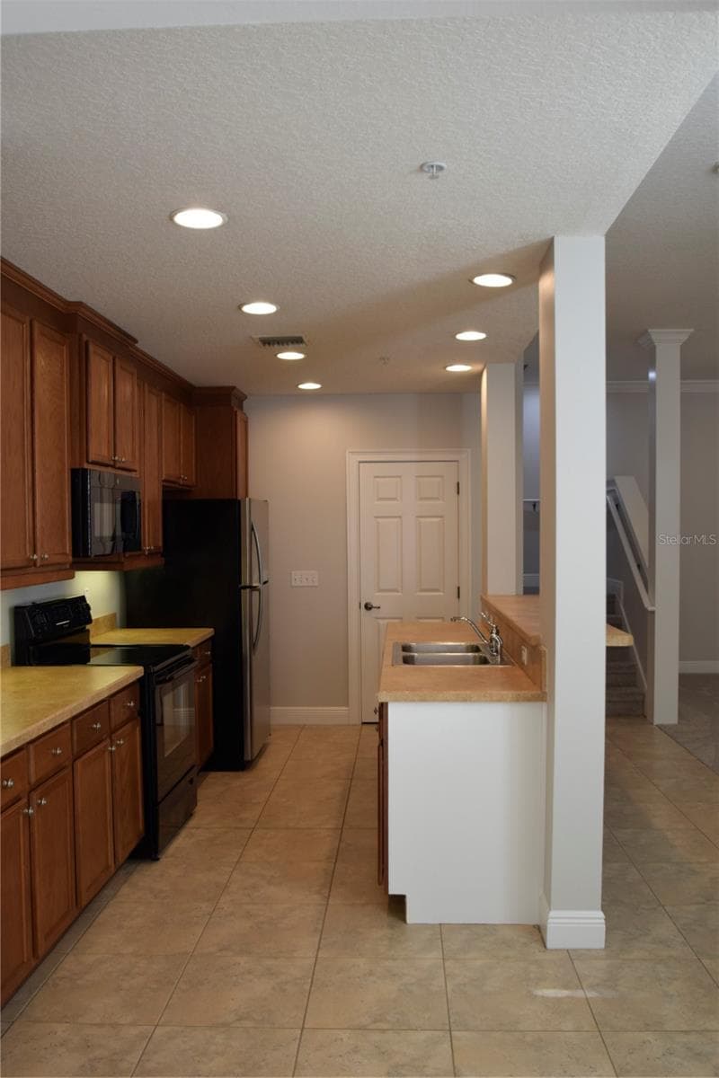 View of kitchen from garage entry. - 1352 LAKE BALDWIN LN #A, ORLANDO