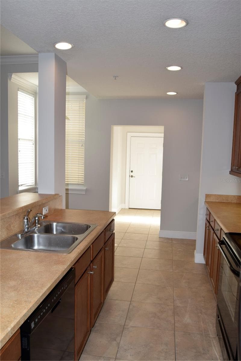 View from kitchen toward garage entry with half bath on the right by the entry door. - 1352 LAKE BALDWIN LN #A, ORLANDO