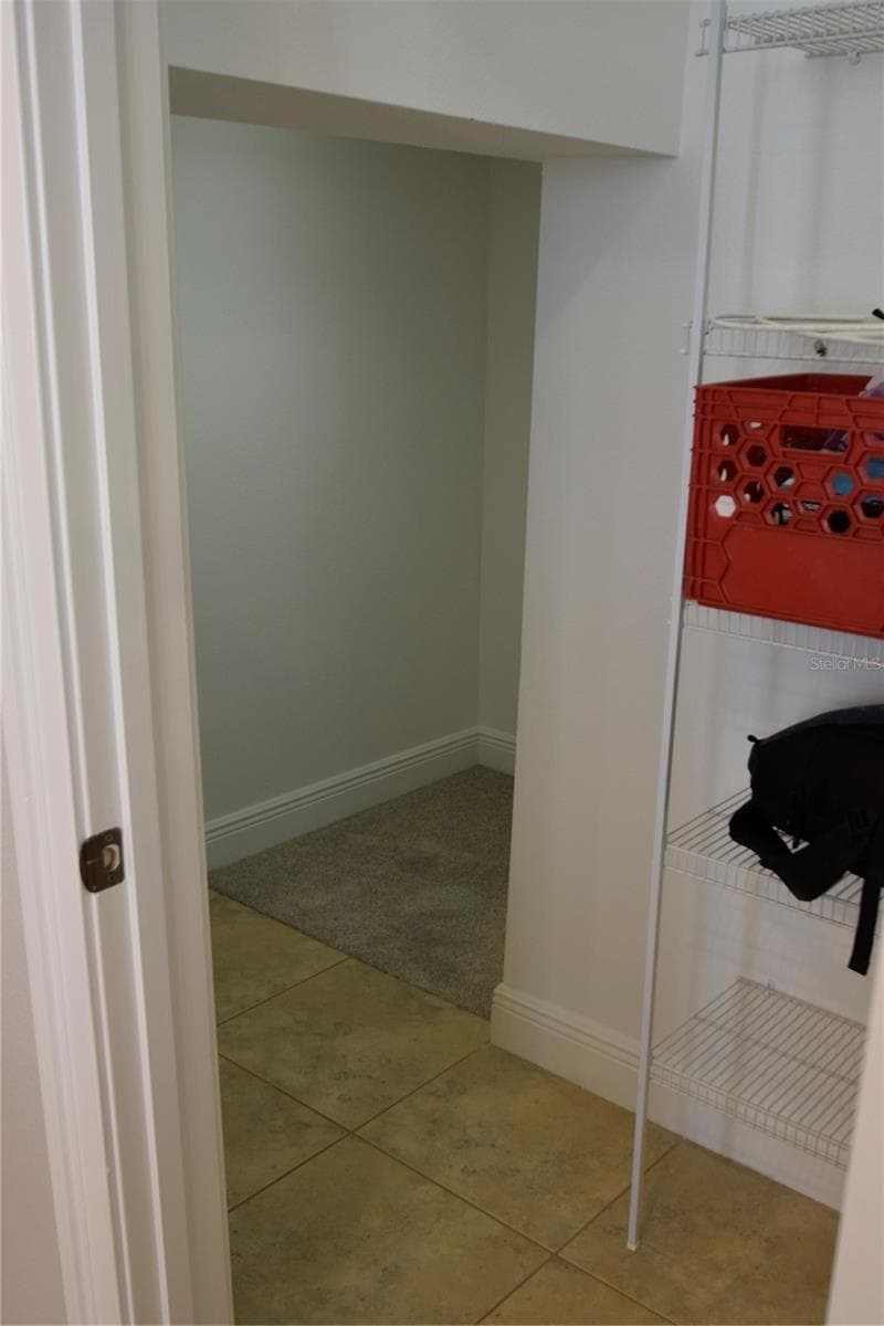 Large pantry that wraps around under the stairs for lots of storage. - 1352 LAKE BALDWIN LN #A, ORLANDO