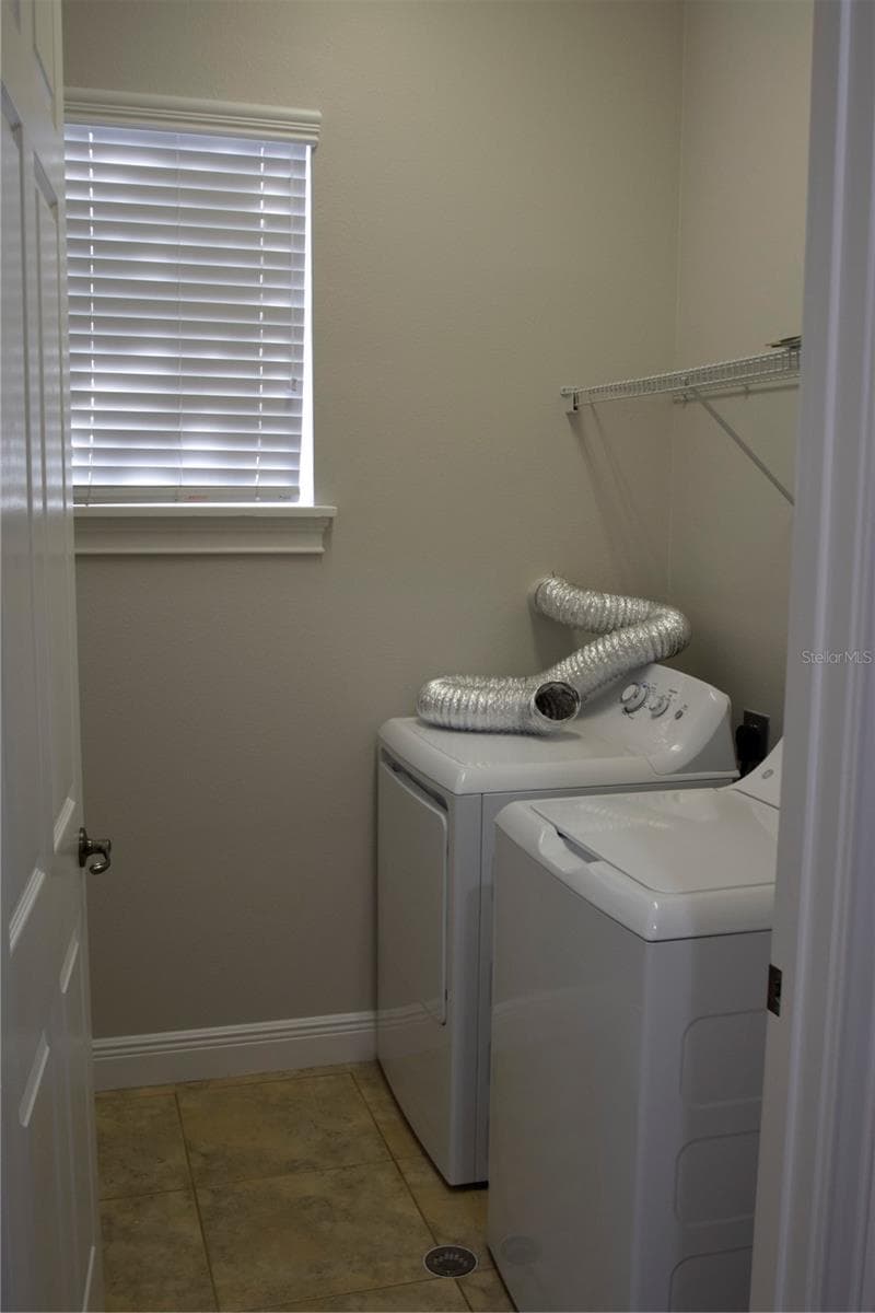 Utility room with W/D in the hallway between the primary bedroom and bedrooms 2&3. - 1352 LAKE BALDWIN LN #A, ORLANDO