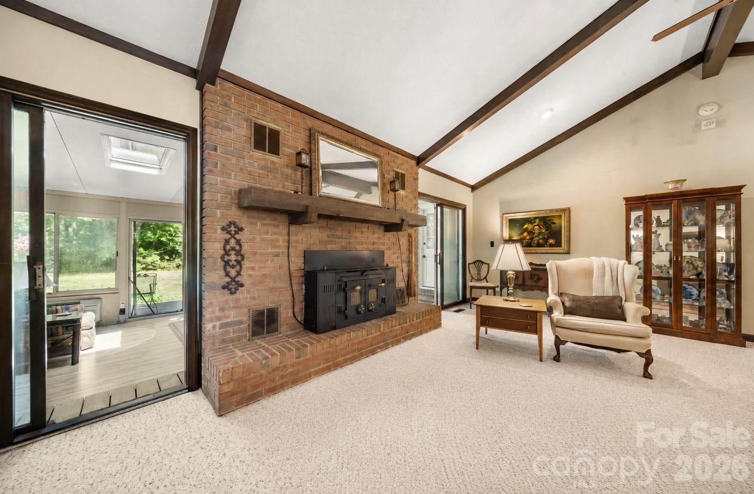 Living room fireplace looking out on to the sunroom - 3426 Driftwood Drive, Gastonia