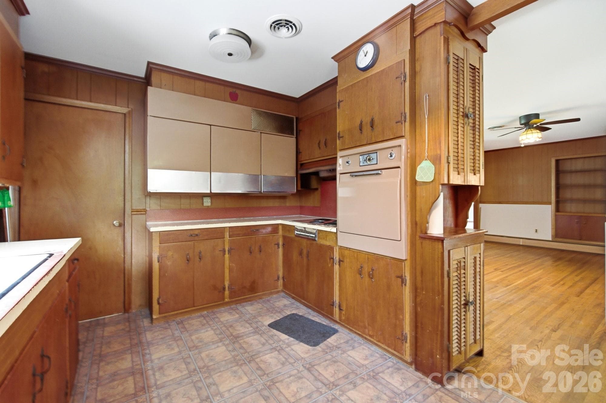 the kitchen retains some of its original mid-century character, including what appears to be a vintage General Electric wall-mounted refrigerator/freezer. Introduced by GE in the mid-1950s as part of its futuristic built-in kitchen concept, these unusual refrigerators were mounted above the countertop to keep food at eye level while leaving valuable cabinet and floor space below. Add in the vintage wall oven and original wood cabinetry - 406 Town Street, Landis