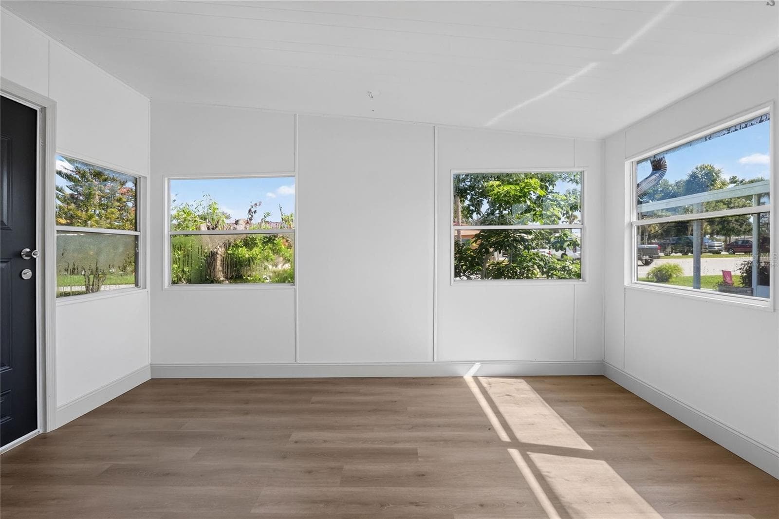 Virtually Staged. Enclosed Florida Room with new mini-split a/c system and view of the lake and community amenities - 2055 S FLORAL AVE #55, BARTOW