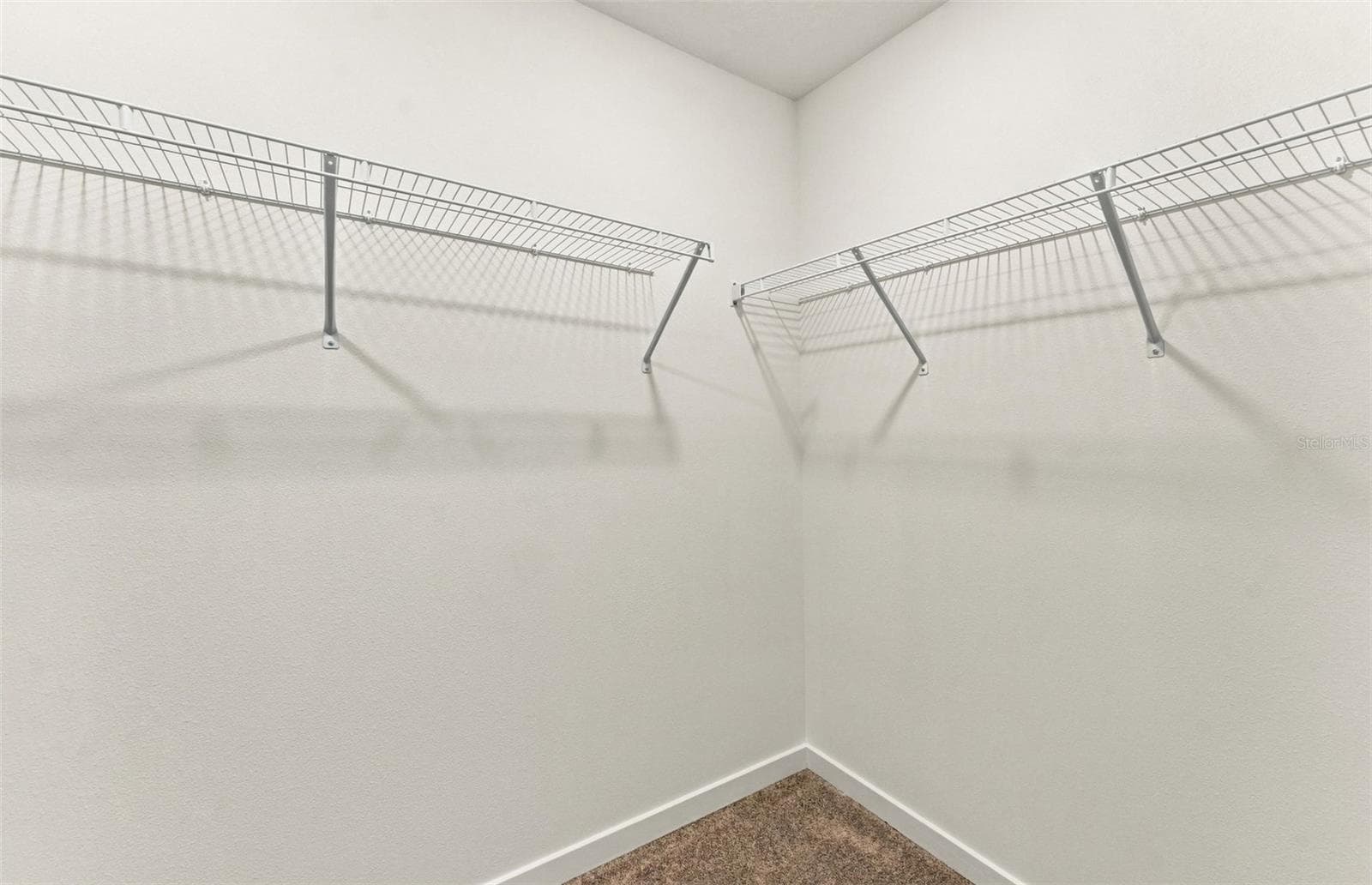 Owner's Walk-in Closet - 9029 WILDLIGHT TRL, WILDWOOD