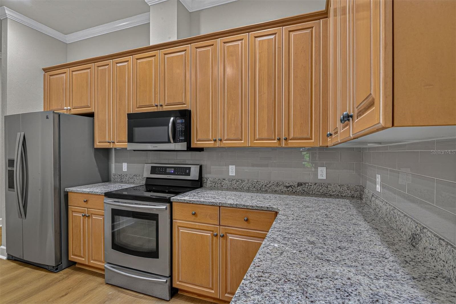 Kitchen with a new backsplash and countertop - 10310 SW 51ST LN, GAINESVILLE