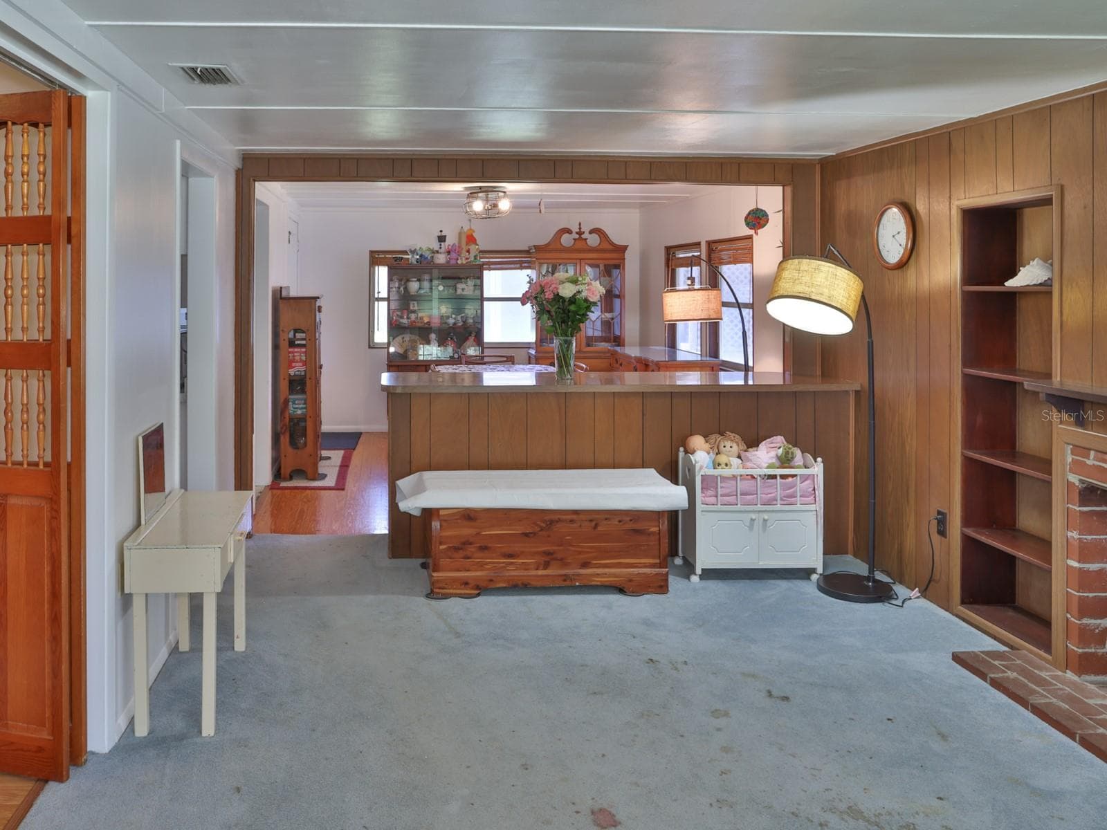 Family room with fireplace and view of the dining room. - 1855 E VALENCIA DR, BARTOW