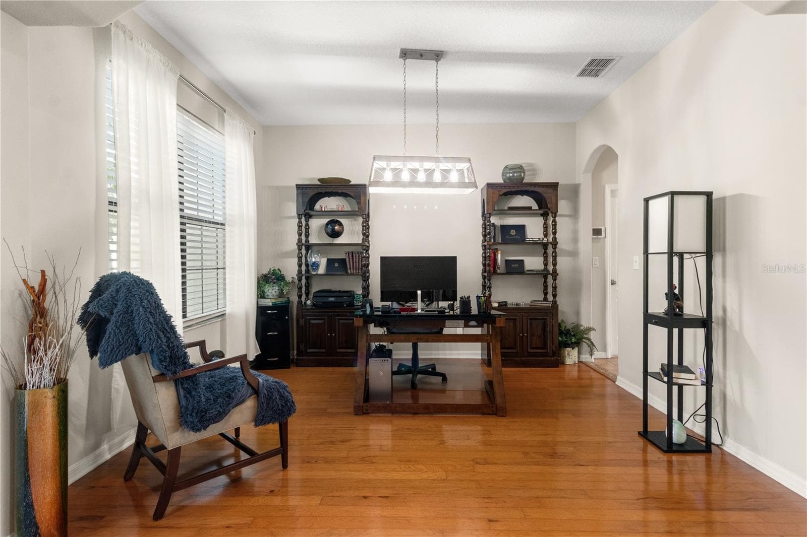 To the left as you enter is the formal dining room, currently used as a stately office - 5824 FISH CROW PL, LAND O LAKES