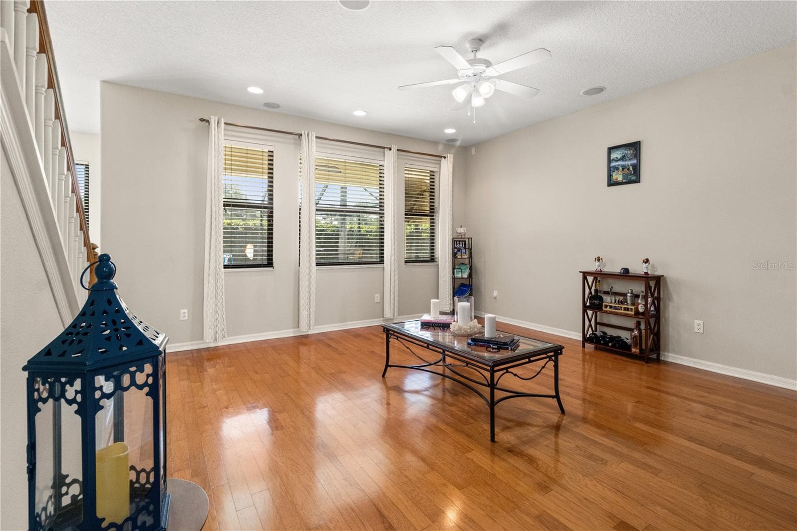 While the family room is large, the hardwood floors give it a cozy feel - 5824 FISH CROW PL, LAND O LAKES