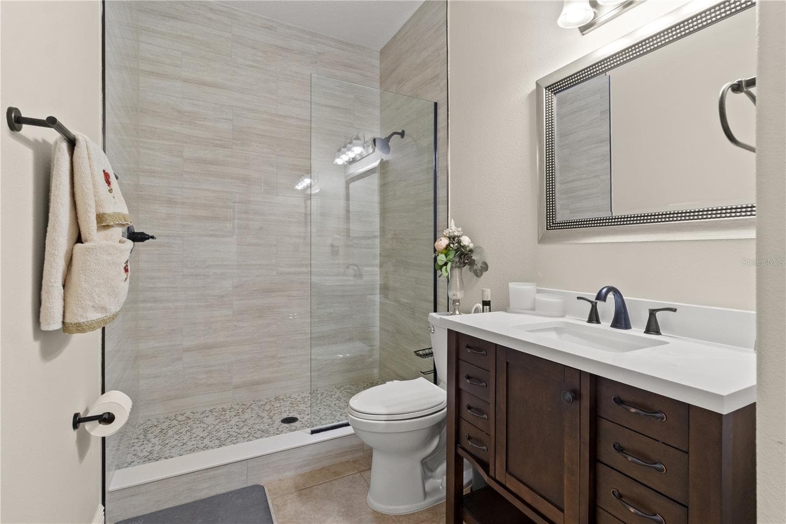 The full bathroom downstairs allows guests a little privacy - 5824 FISH CROW PL, LAND O LAKES