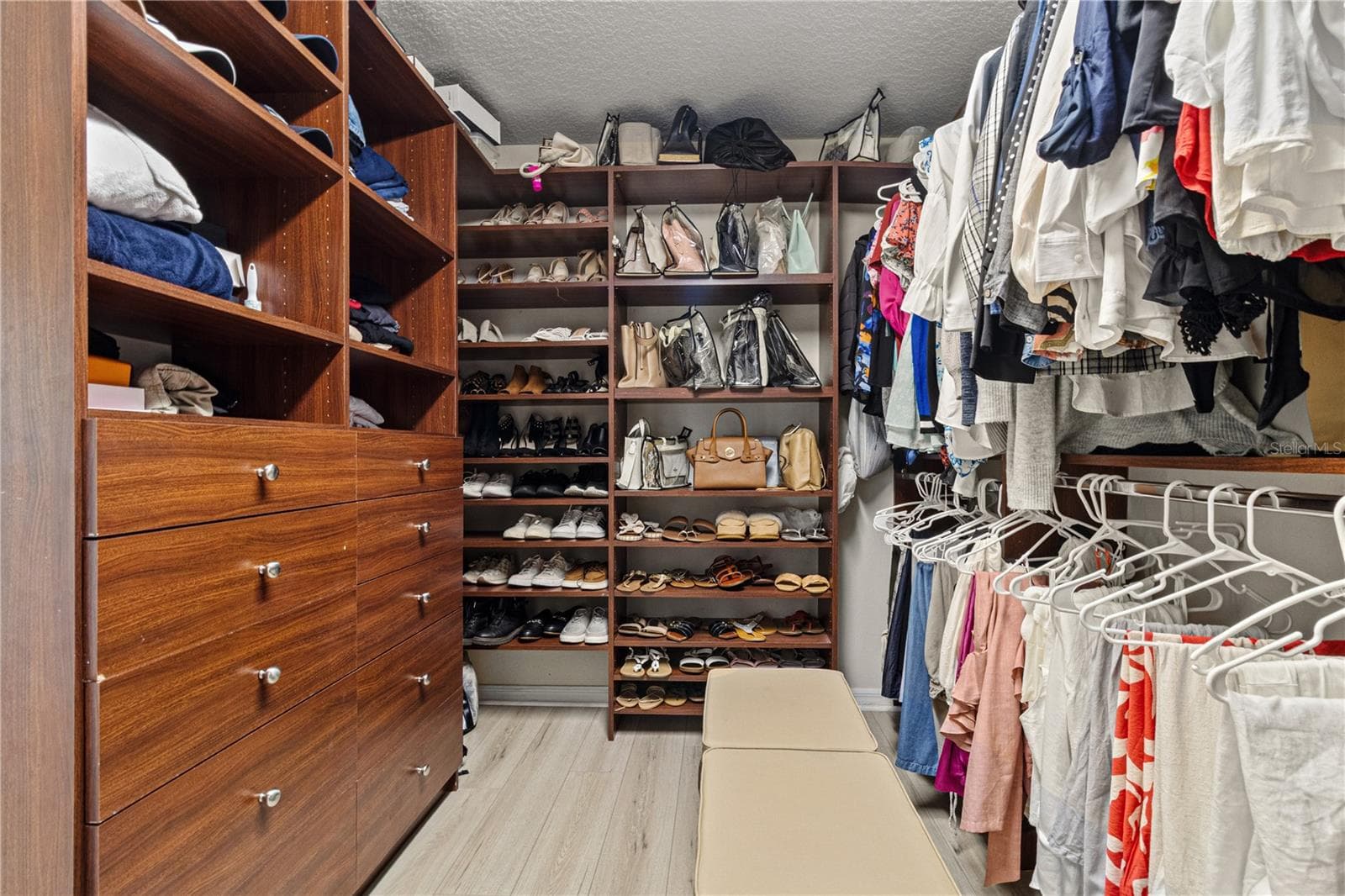 The primary suite walk in closet had built ins to keep it neat and organized. - 5824 FISH CROW PL, LAND O LAKES