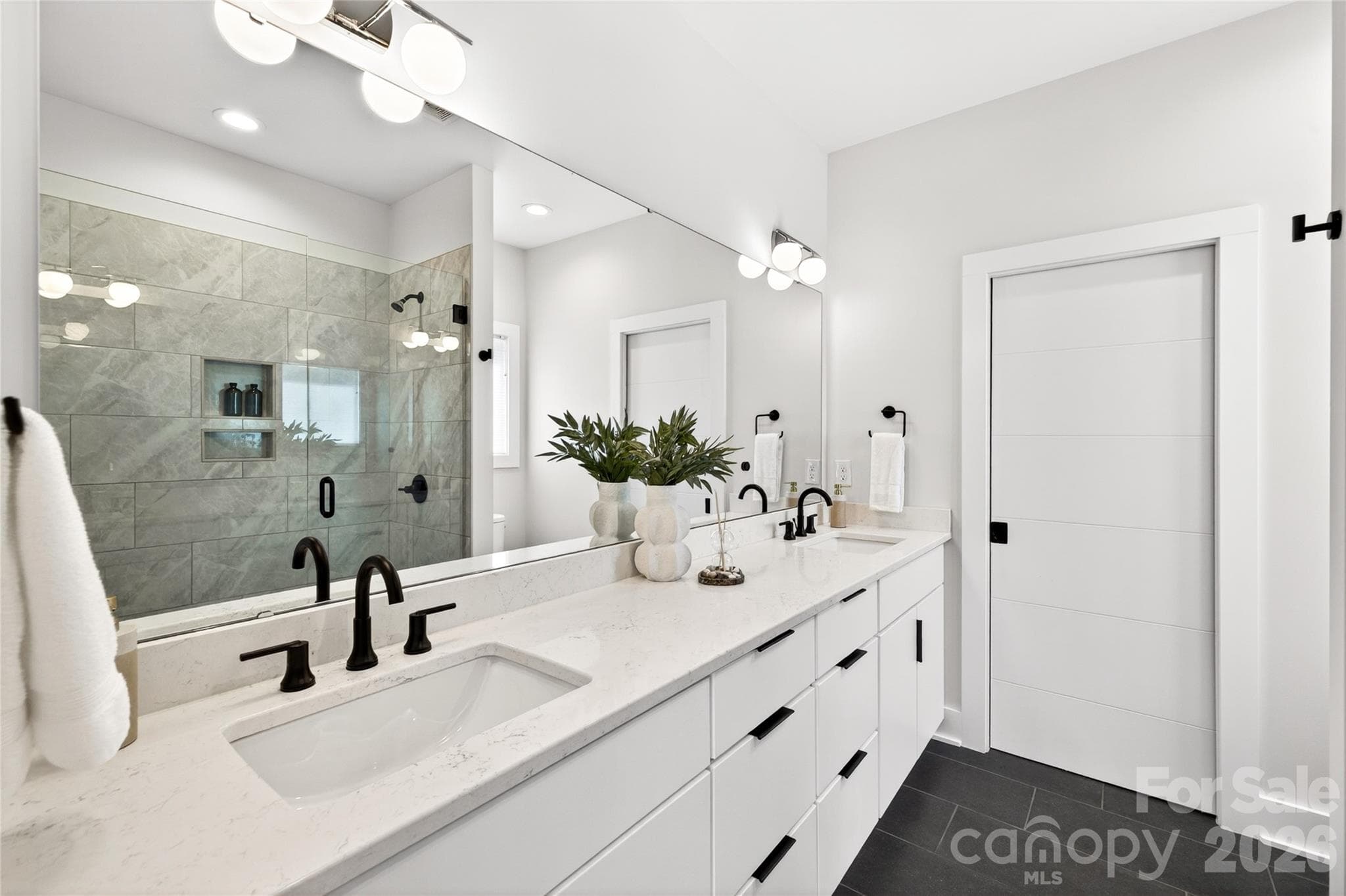 Ensuite bath with dual sinks and oversized shower with glass doors. - 5044 Double Lakes Drive, Charlotte
