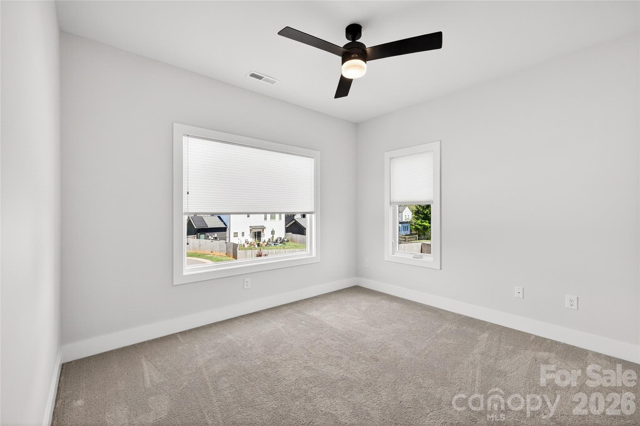 Secondary bedroom with ceiling fan. - 5044 Double Lakes Drive, Charlotte