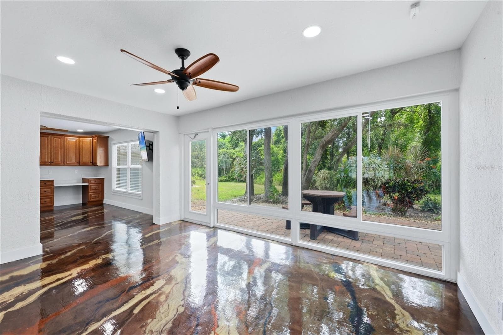 The Florida room features a wall of windows that fills the space with natural light and brings the outdoors in. Impact windows! - 259 PARK FOREST BLVD, ENGLEWOOD