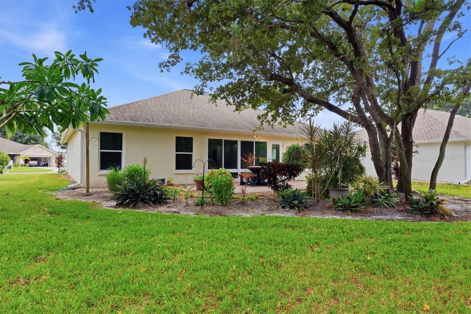 The home has a private backyard with paver patio and wooded view. - 259 PARK FOREST BLVD, ENGLEWOOD