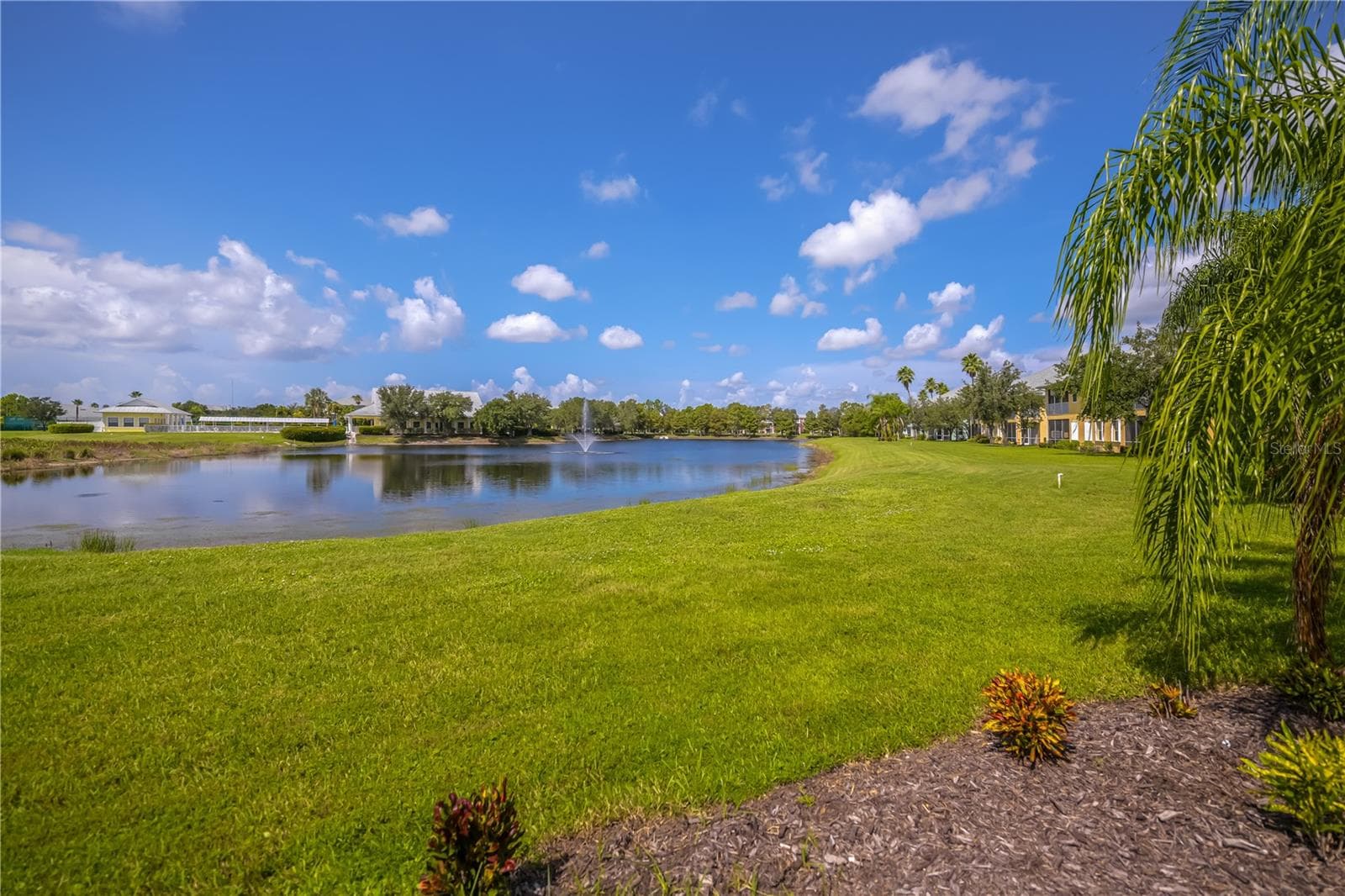 Sensational sunset hues over the lake while the gentle fountain sounds are what you will enjoy from your private lanai. - 25545 HERITAGE LAKE BLVD #21, PUNTA GORDA