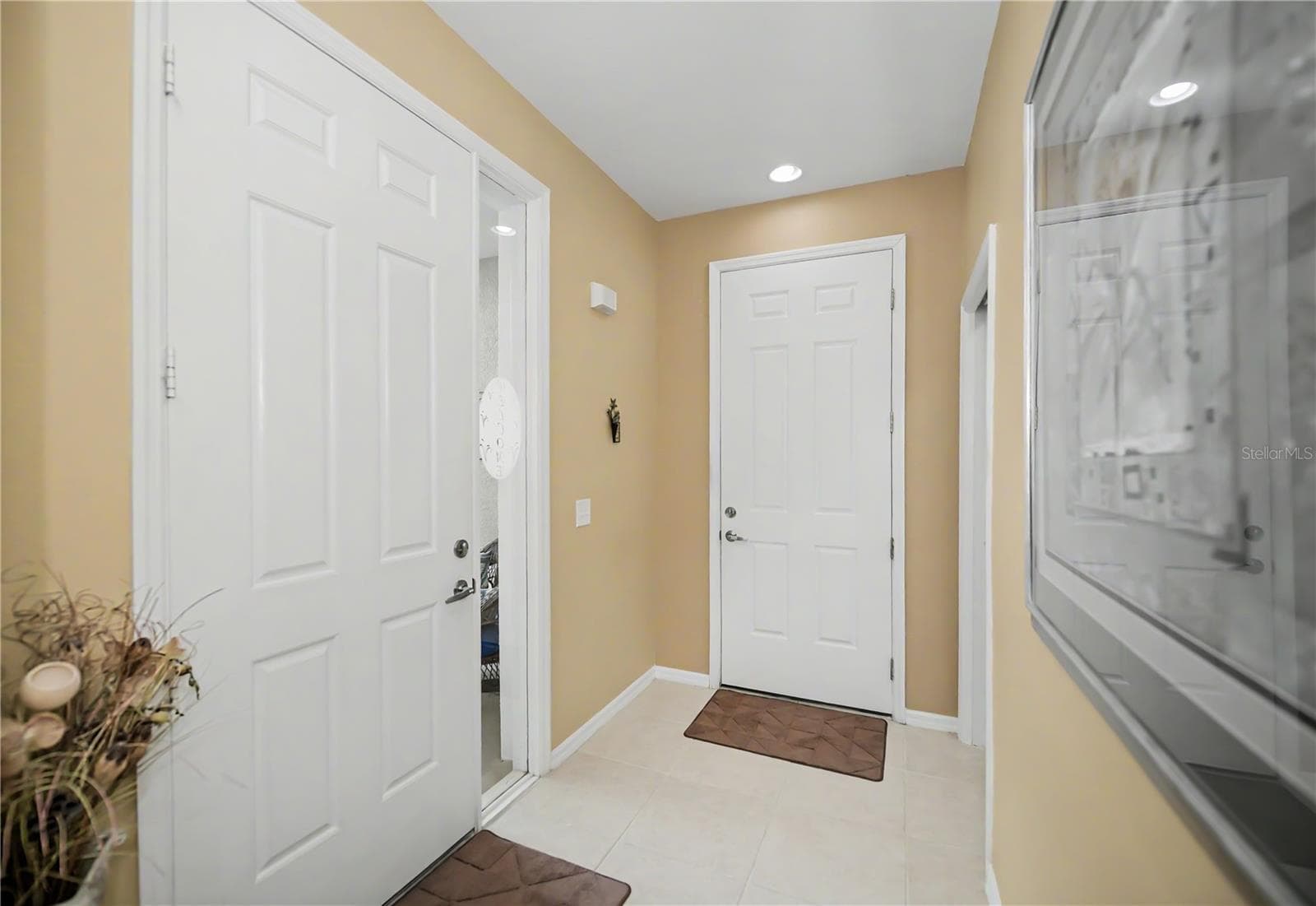side entry front door and garage door opens to your foyer entry - 25545 HERITAGE LAKE BLVD #21, PUNTA GORDA