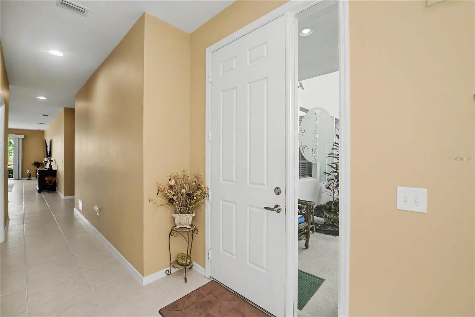 covered side porch entry - 25545 HERITAGE LAKE BLVD #21, PUNTA GORDA
