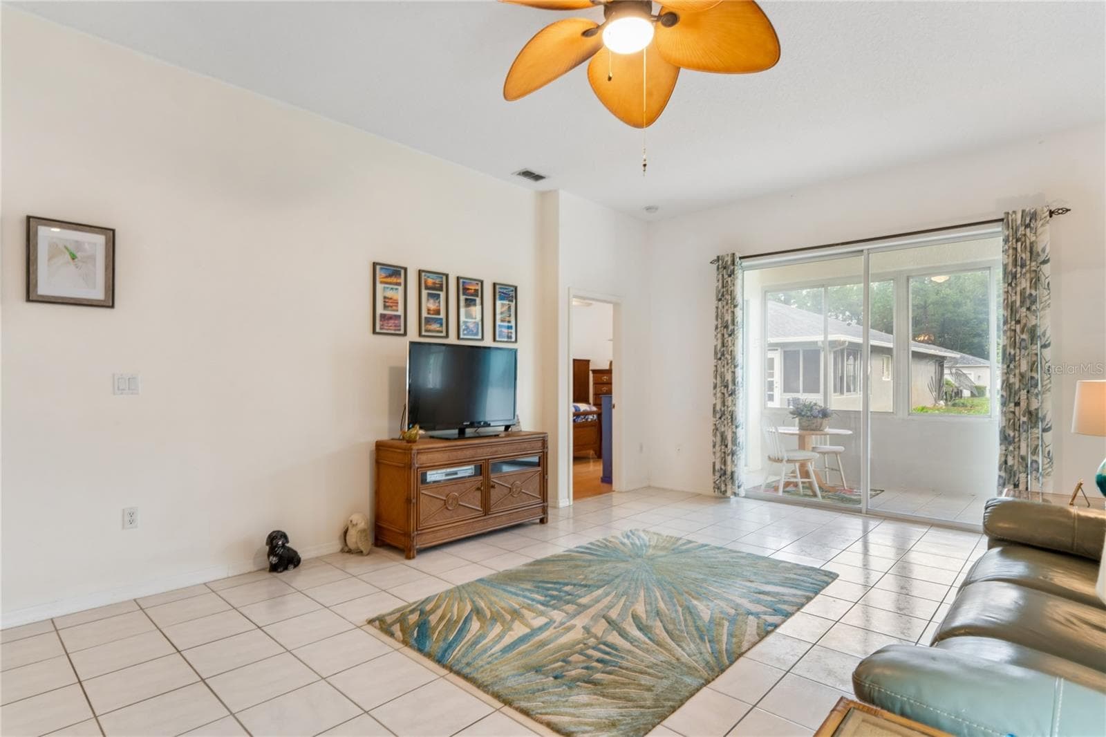 OUTSIDE SCREENED LIVING AREA IS ACCESSABLE THROUGH SGD - SUMMERTREE PRCL 03A PH 02, NEW PORT RICHEY