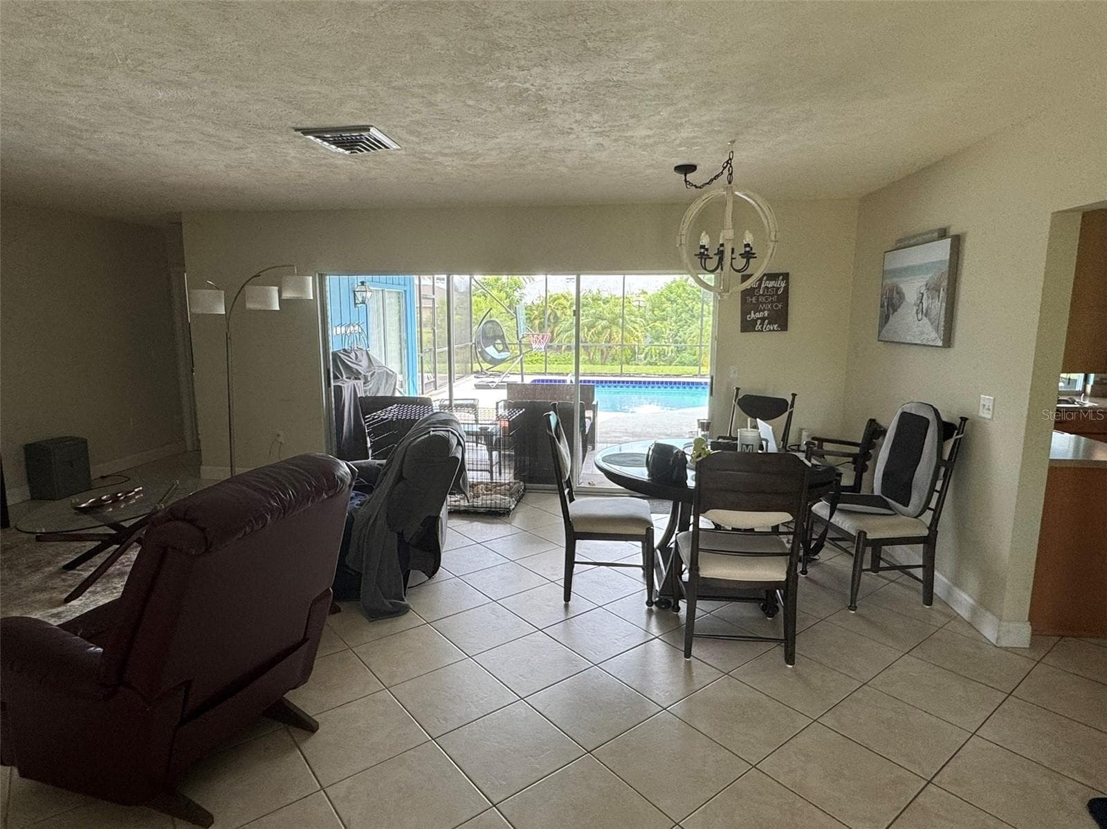 Living/dining area overlooking pool - 1009 INDIAN HILLS CT, VENICE