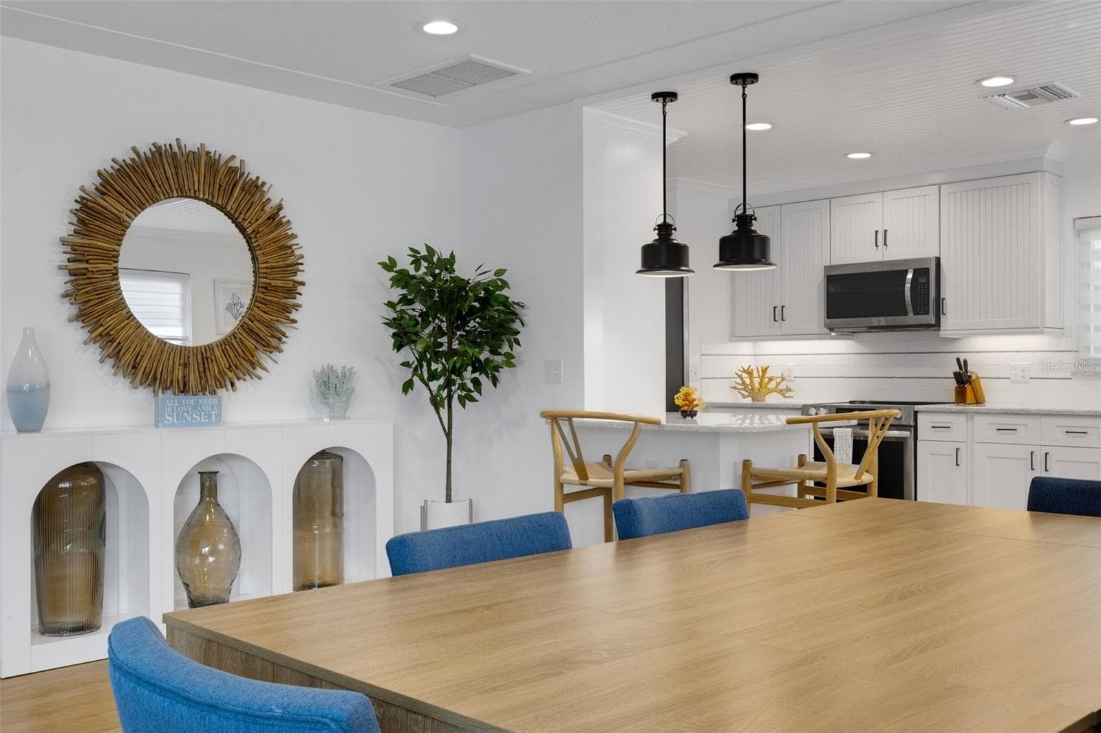 Dining area and breakfast bar create plenty of space for gathering and entertaining. - 18317 SUNSET BLVD, REDINGTON SHORES