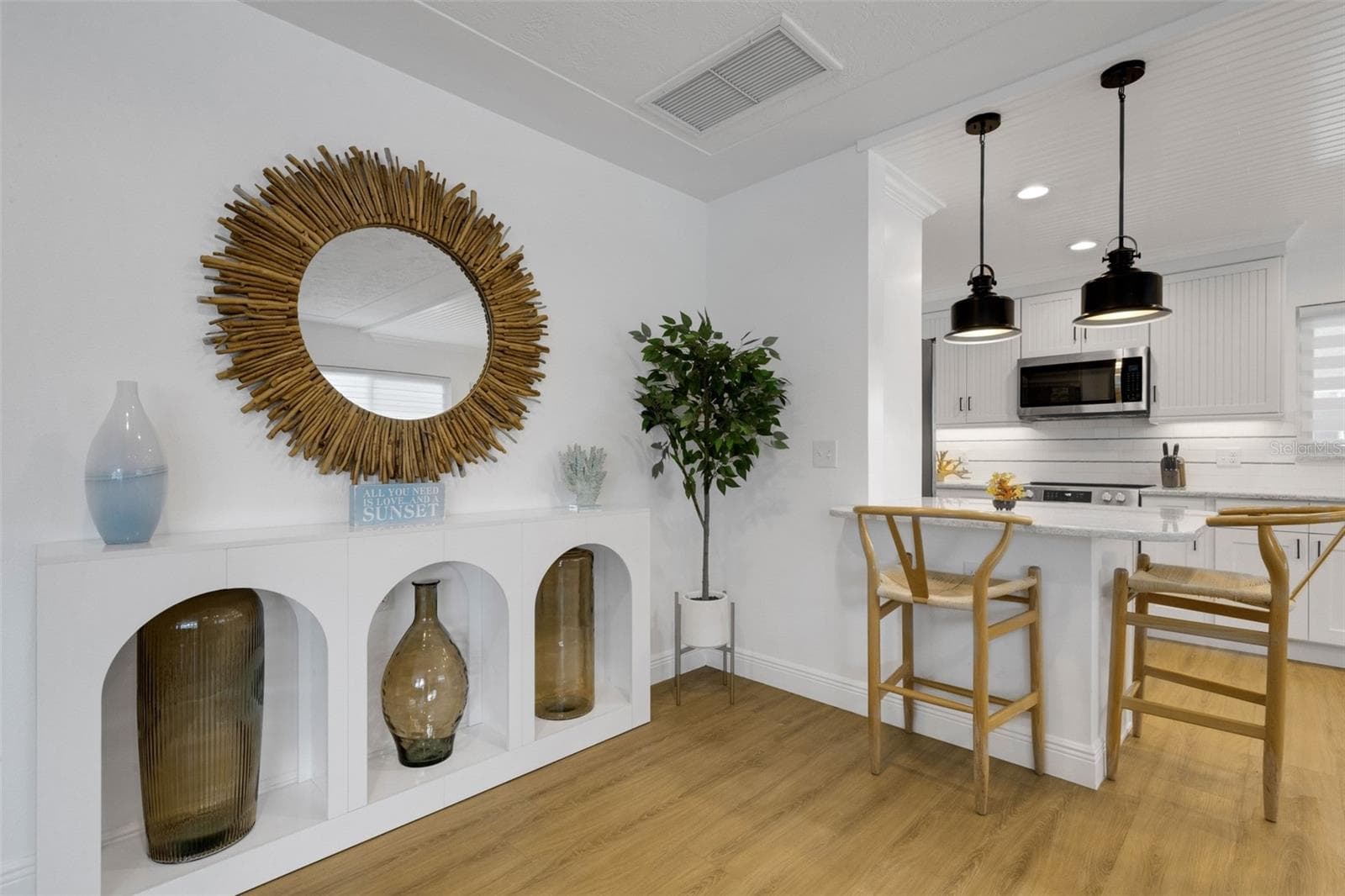 Stylish breakfast bar connects the dining area to the kitchen. - 18317 SUNSET BLVD, REDINGTON SHORES