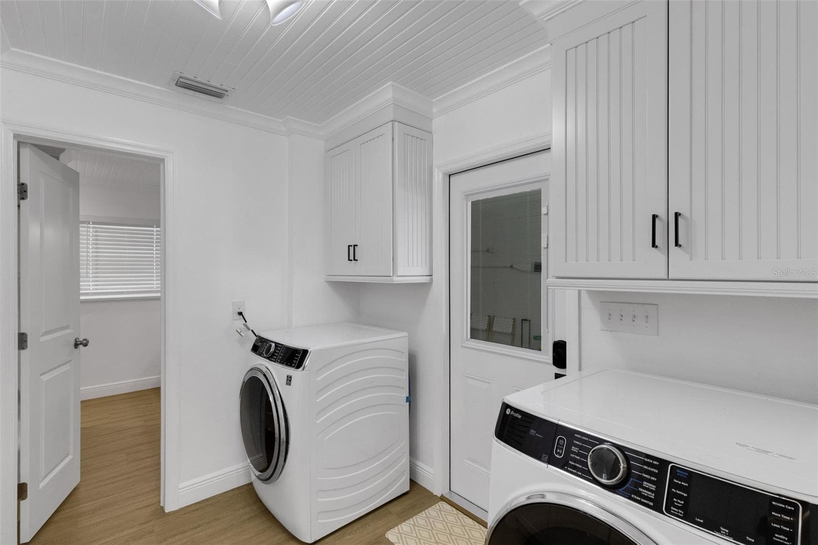 Dedicated laundry area with full-size washer and dryer plus built-in cabinetry - 18317 SUNSET BLVD, REDINGTON SHORES