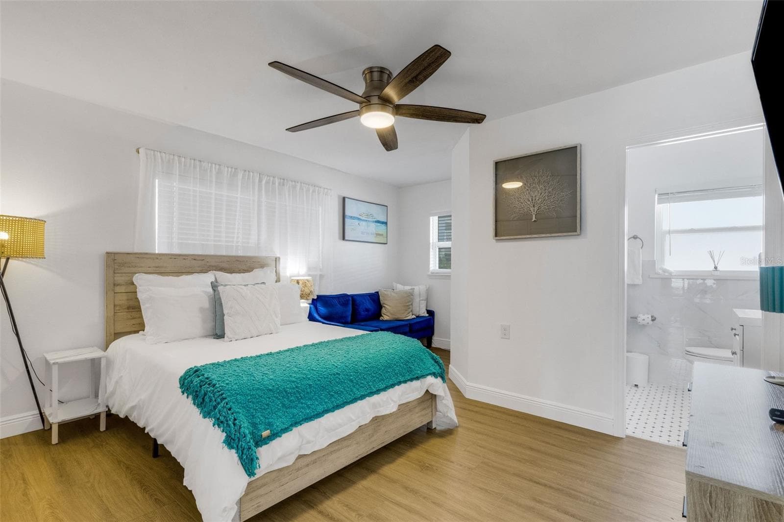 Primary bedroom features generous closet space and beautiful updated flooring. - 18317 SUNSET BLVD, REDINGTON SHORES