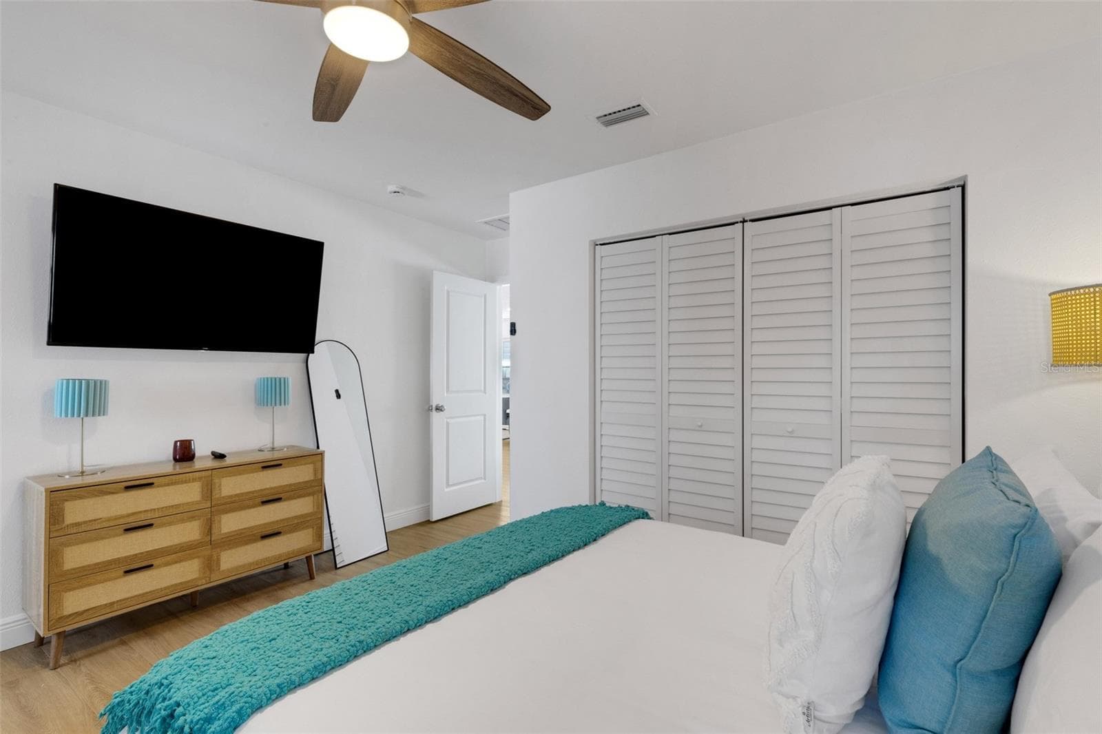 Primary suite includes wall-mounted TV, dresser and convenient ensuite bath access. - 18317 SUNSET BLVD, REDINGTON SHORES