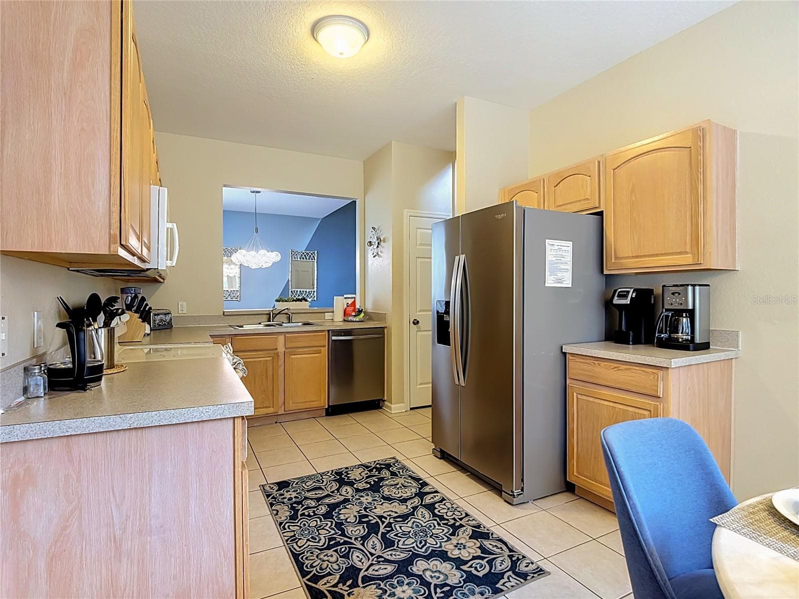 Kitchen offering ample cabinet and counter space. - 7742 COMROW ST, KISSIMMEE