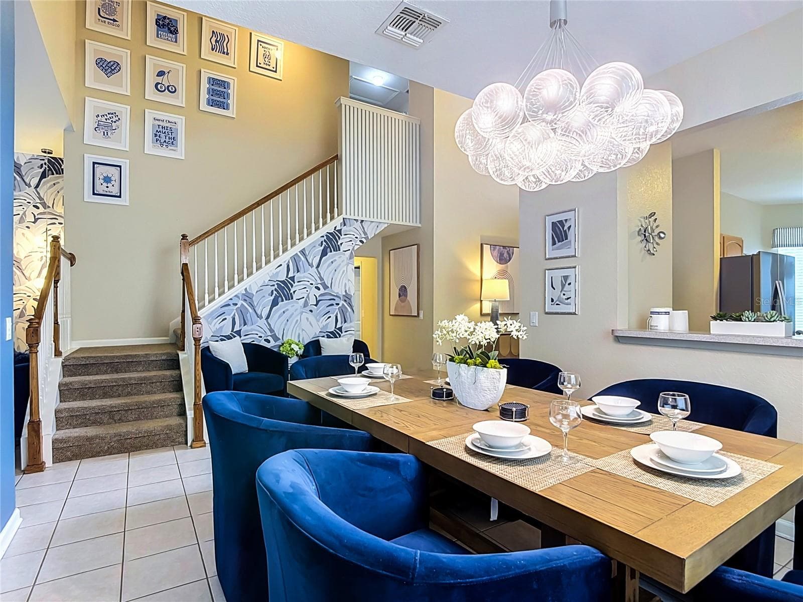 Open-concept layout connecting the kitchen, dining, and living areas. - 7742 COMROW ST, KISSIMMEE