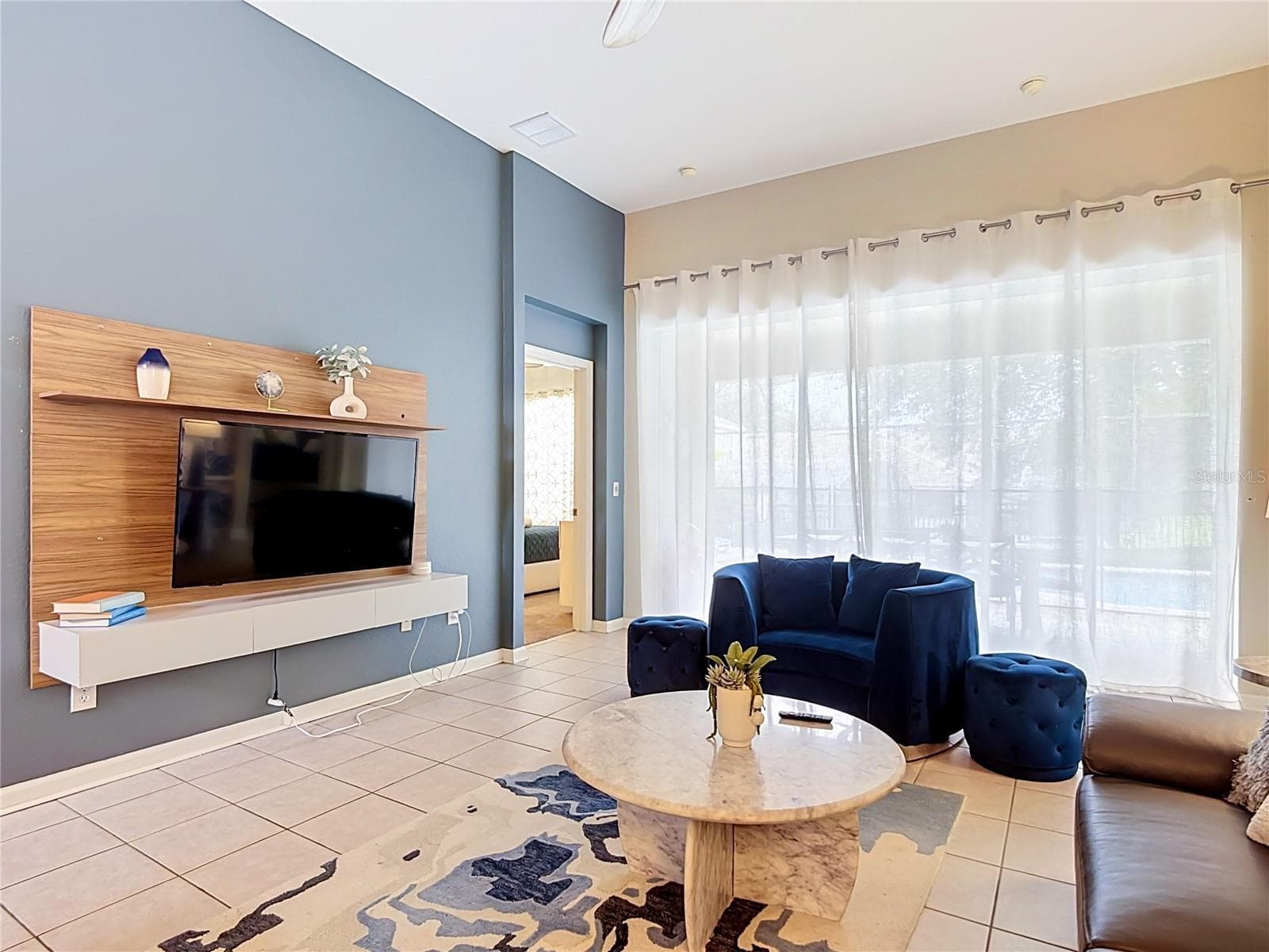 Another view of the spacious living room and entertainment area. - 7742 COMROW ST, KISSIMMEE