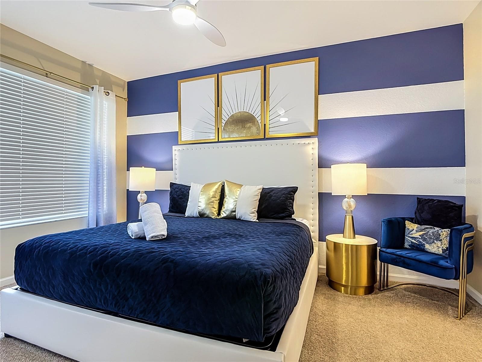 First-floor primary suite with king bed and private ensuite bathroom. - 7742 COMROW ST, KISSIMMEE