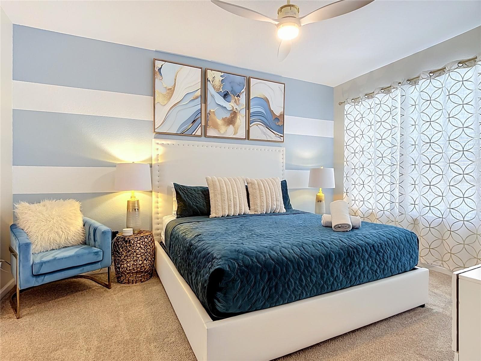 Second first-floor primary suite with king bed and private ensuite bathroom. - 7742 COMROW ST, KISSIMMEE