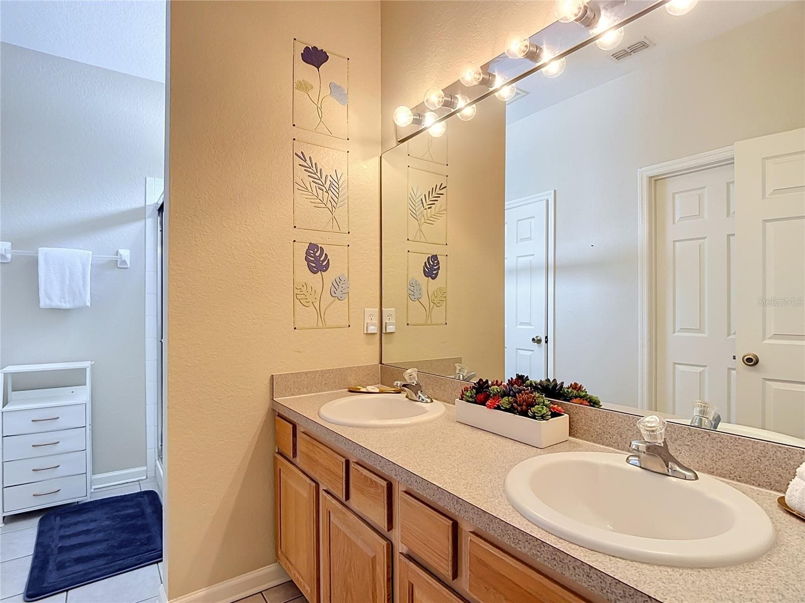 Ensuite bathroom for the second first-floor primary suite. - 7742 COMROW ST, KISSIMMEE