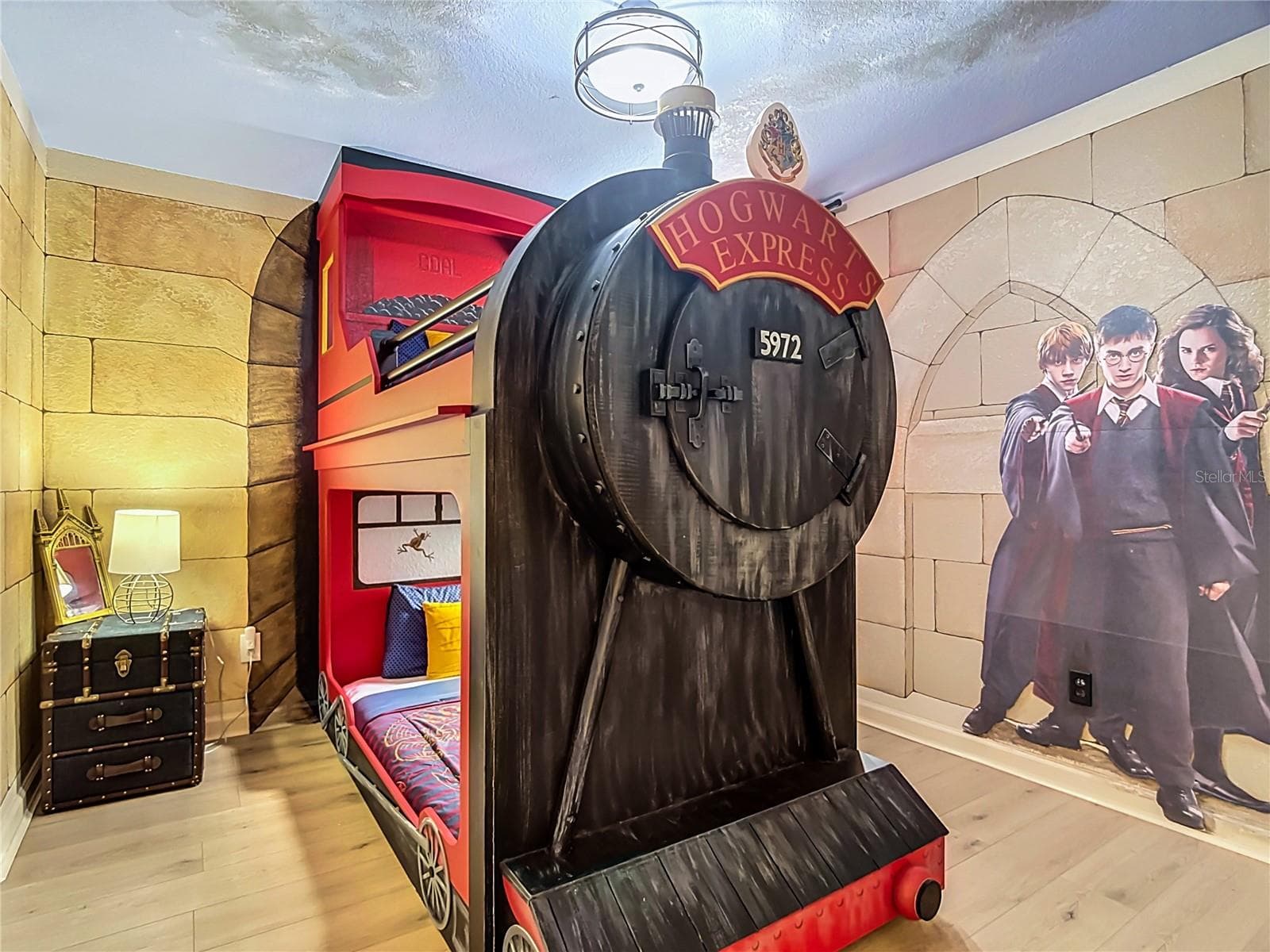 Harry Potter-themed bedroom with custom Hogwarts Express bunk bed and private ensuite bathroom. - 7742 COMROW ST, KISSIMMEE