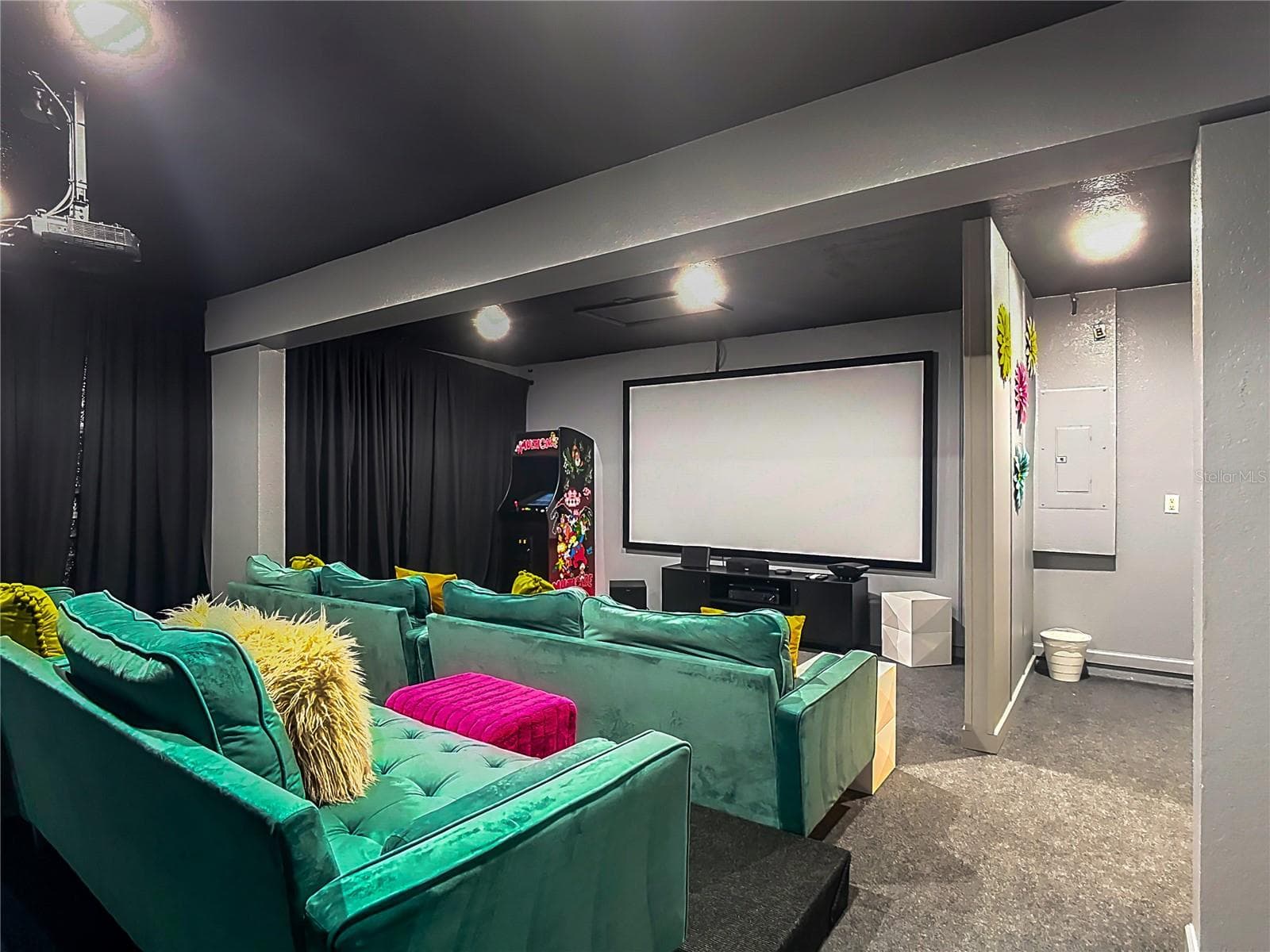 Dedicated theater room with oversized seating, projector, aracde machine and cinema screen. - 7742 COMROW ST, KISSIMMEE