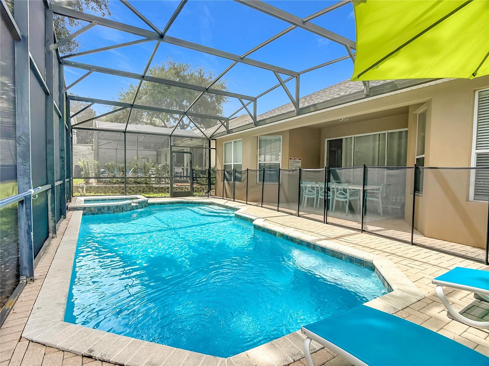 Heated pool and spa enclosed by an expansive screened lanai. - 7742 COMROW ST, KISSIMMEE