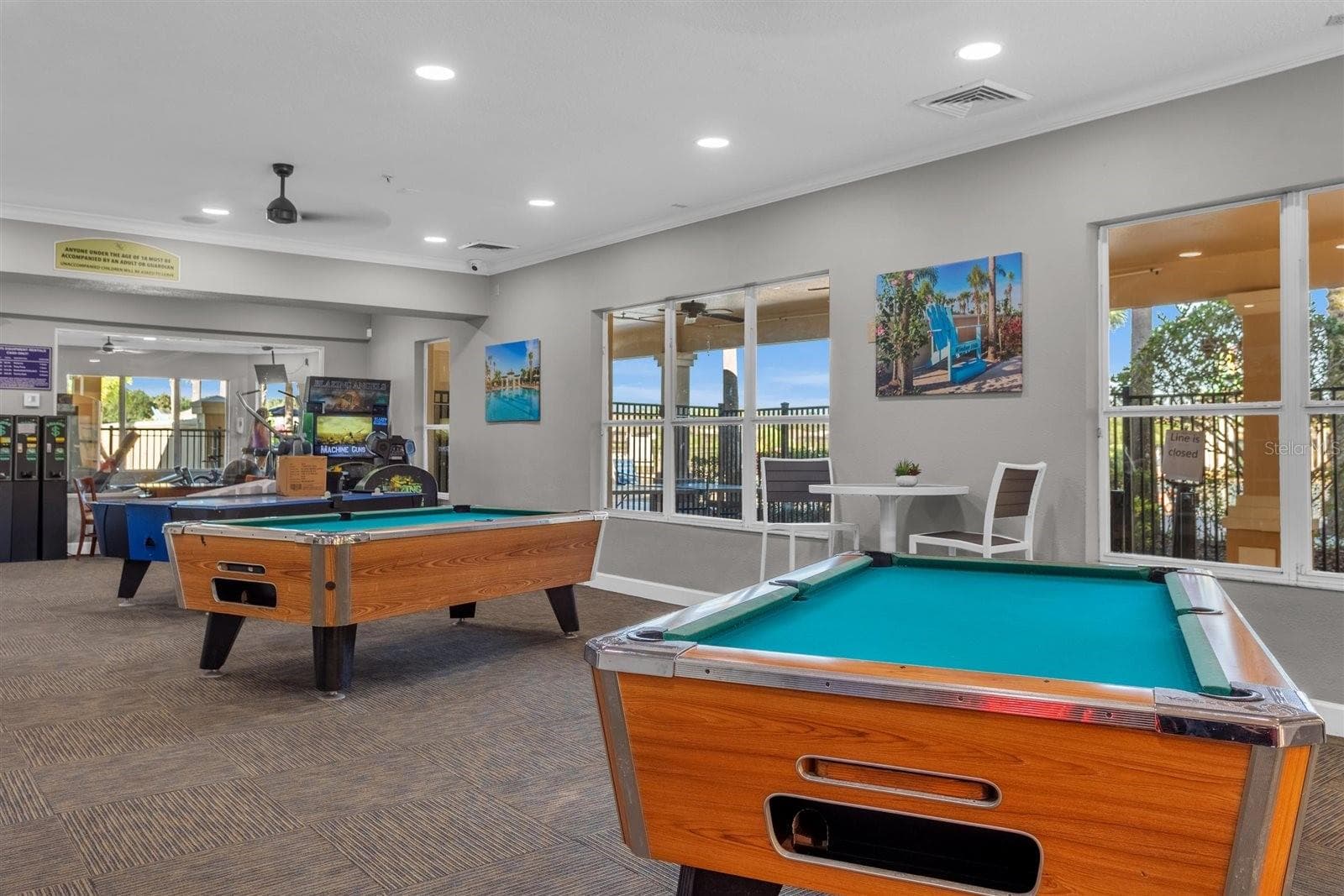 Clubhouse game room with pool tables and additional entertainment. - 7742 COMROW ST, KISSIMMEE