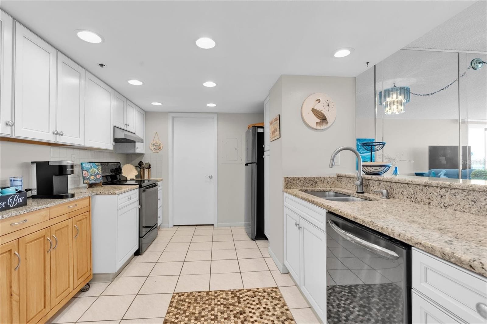 Open Kitchen with Water Views Beyond the Living Area - 6287 BAHIA DEL MAR CIR #401, ST PETERSBURG