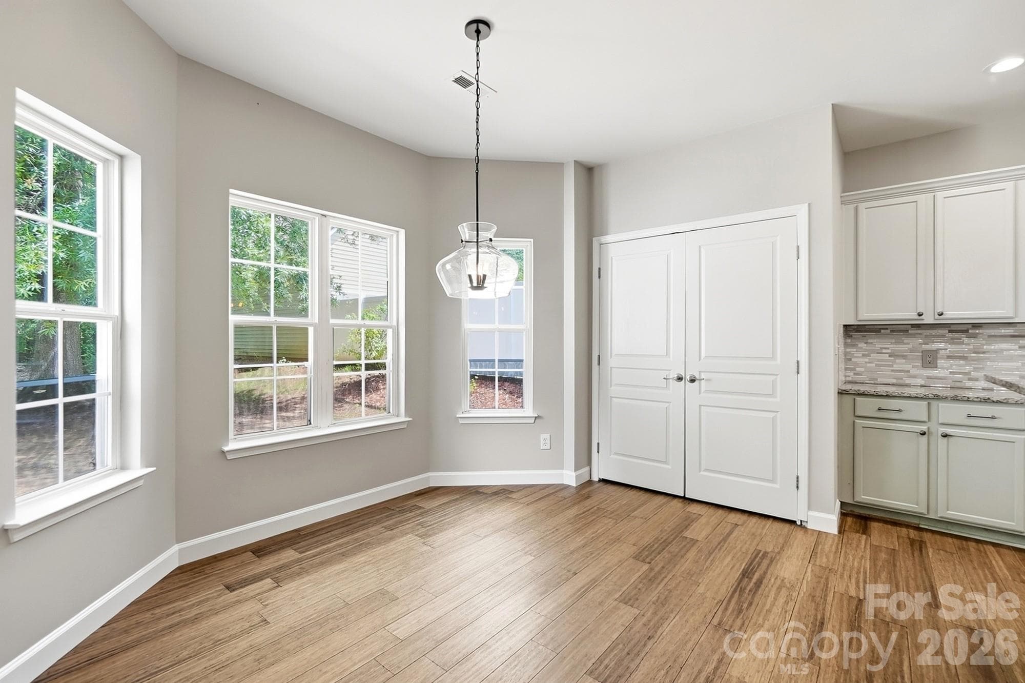 Laundry room conveniently located in kitchen and has cabinetry for storage - 11402 Heritage Green Drive, Cornelius